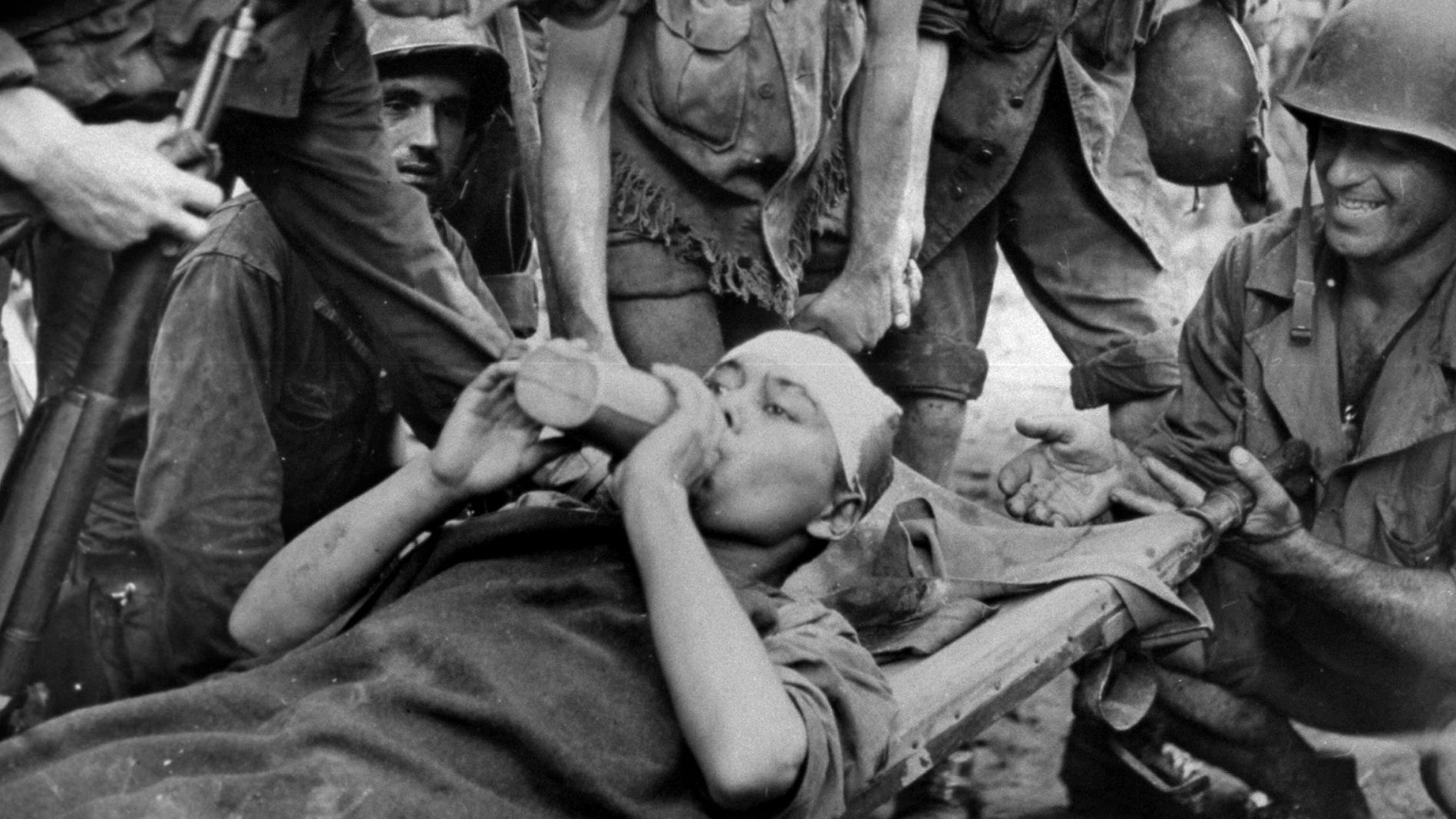 A Korean pressed into working as a slave laborer for the Japanese on the island of New Guinea receives medical treatment after his liberation. Thousands of Koreans were forced to construct installations and fortifications across the Pacific for their Japanese captors.