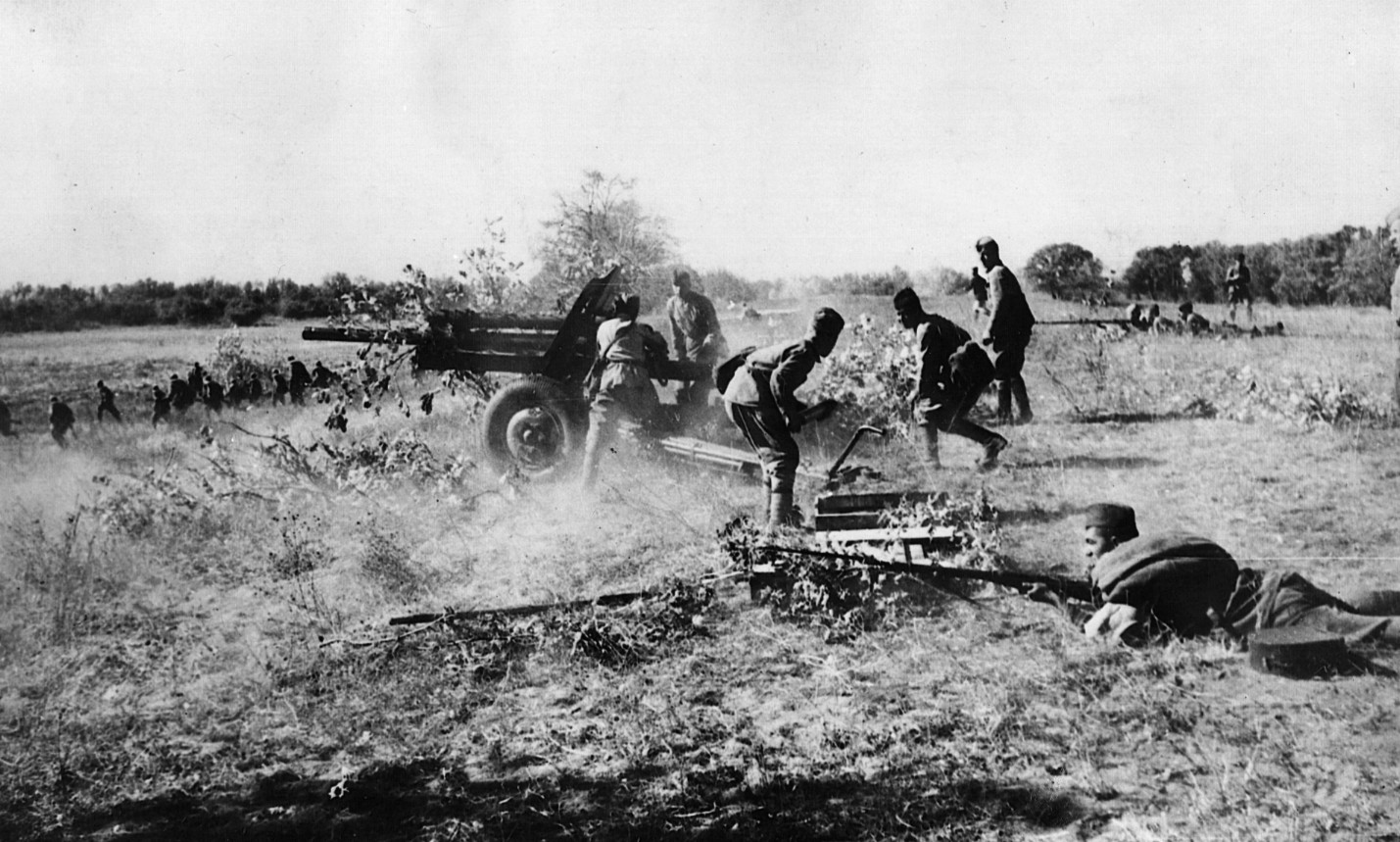 Russian infantry service field artillery and fire small arms at attacking Germans in defense of the Kursk salient.