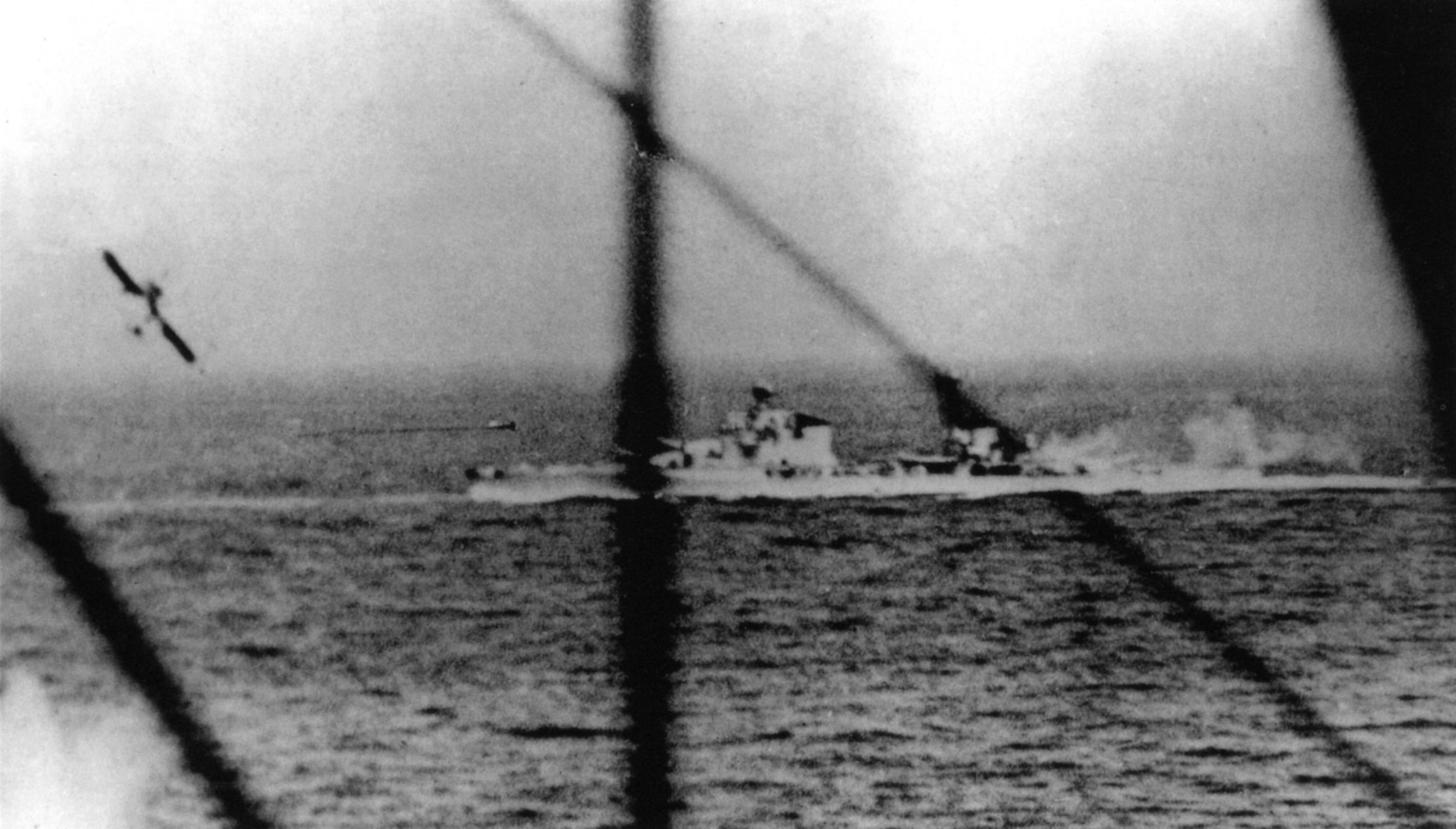 A British Fairey Albacore torpedo bomber pulls up after releasing its weapon toward the Italian heavy cruiser Pola. This photograph was taken from a Fairey Swordfish, another type of Royal Navy torpedo plane. 