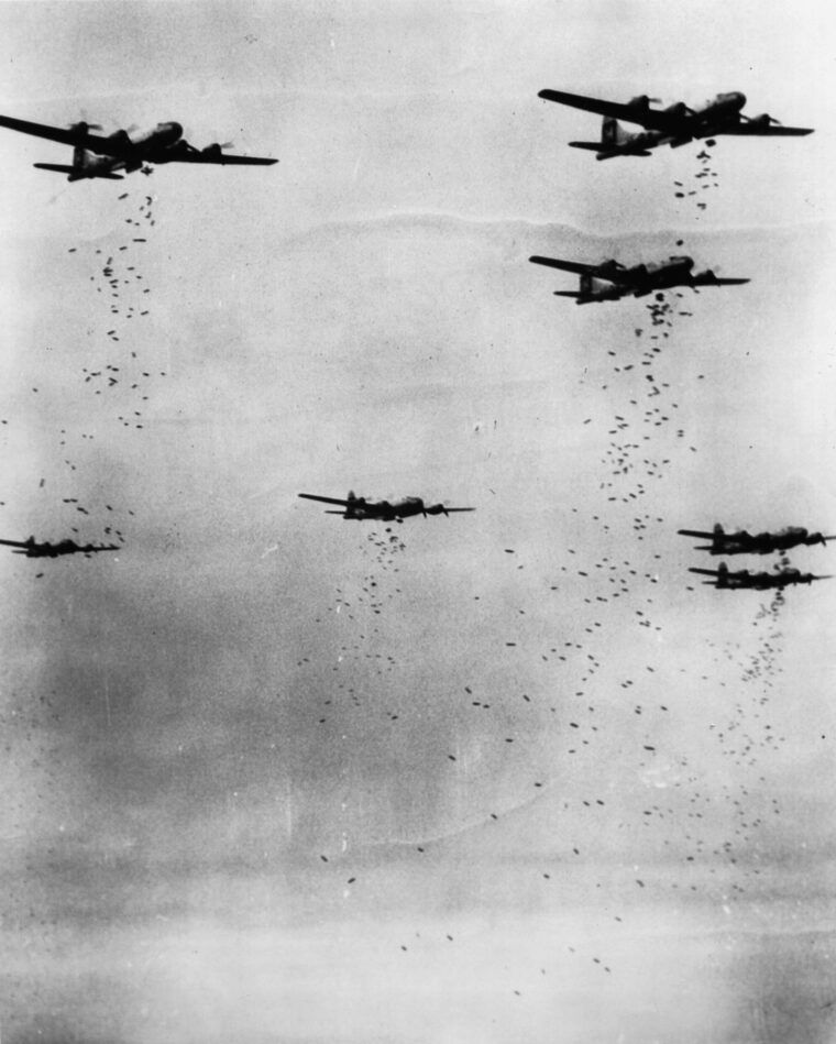 Boeing B-29 Superfortresses drop their bomb loads above a target on the Japanese home islands. Logistical problems caused the effort to be abandoned, particularly after U.S. bases on the Marianas became operational.