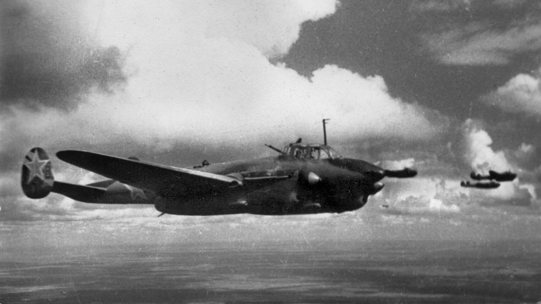 Petlyakov Pe-2 dive bombers are shown flying in formation toward an enemy target. The Pe-2 was a highly successful light aircraft used throughout World War II and into the 1950s.