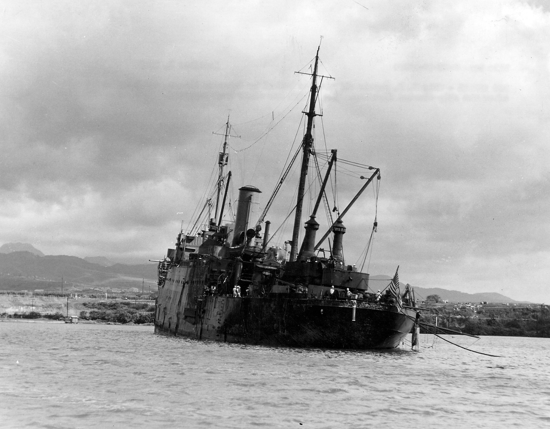 After being twice bombed by Japanese fliers, the USS Vestal sits beached following flooding triggered from the damage she sustained.