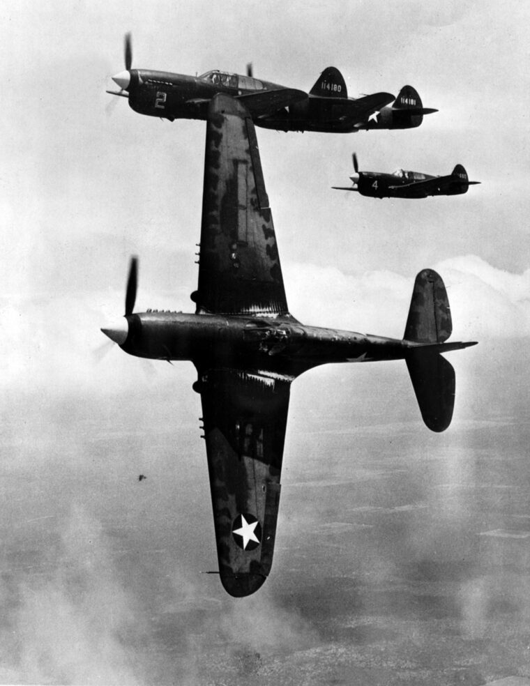 The lead plane in this formation of P-40 Tomahawks wings over to attack a formation of enemy planes. The Flying Tigers scored an impressive kill ratio against veteran Japanese pilots. 