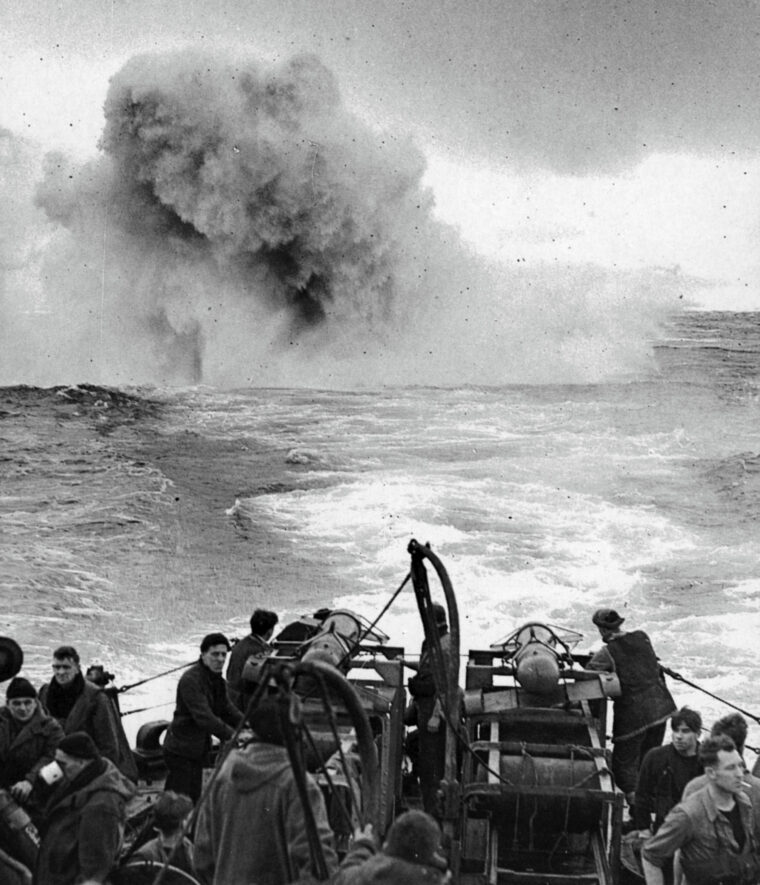 A plume of water shoots skyward as a German U-boat is struck by a barrage of depth charges and “Hedgehog” bombs. 