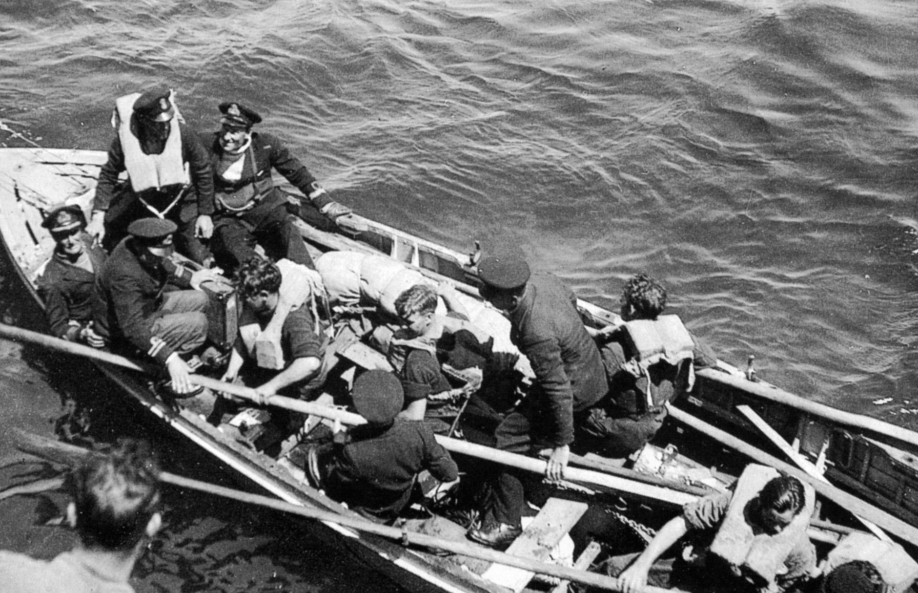 Walker and several of his key men arrive at HMS Wild Goose shortly after ramming U-119 aboard the HMS Starling.