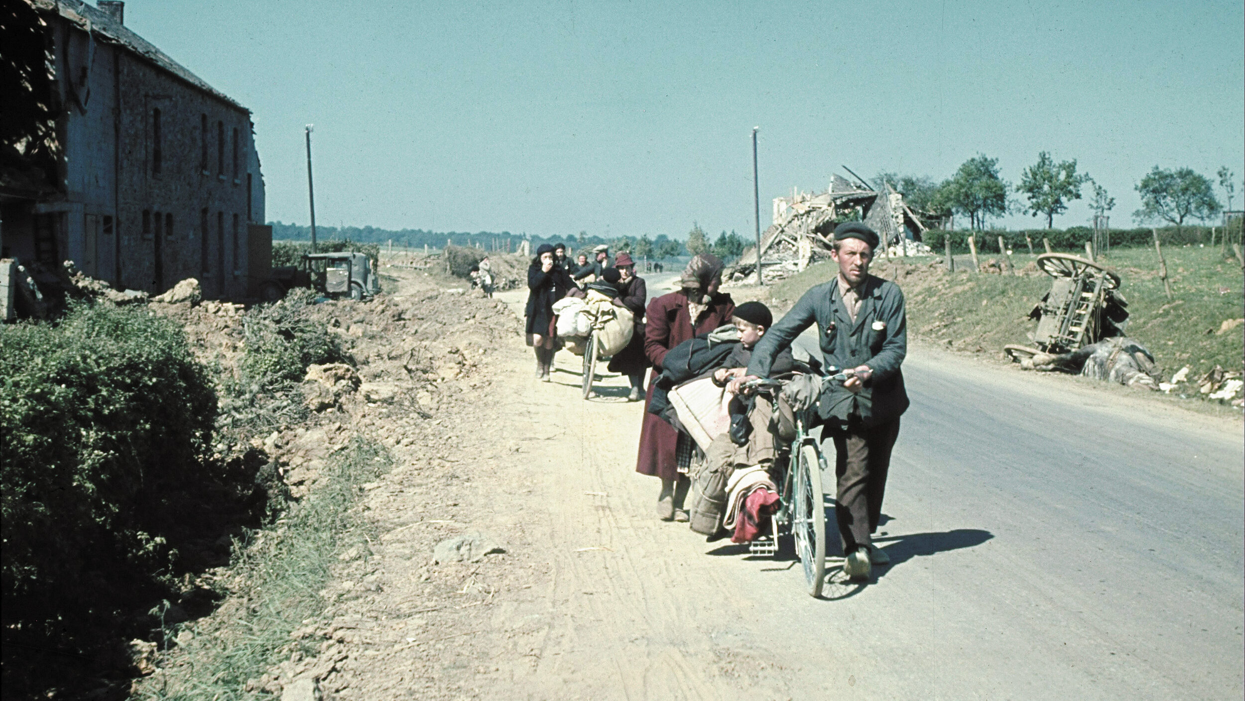 With whatever personal possessions they can manage, Belgian refugees flee the German army in the summer of 1940.