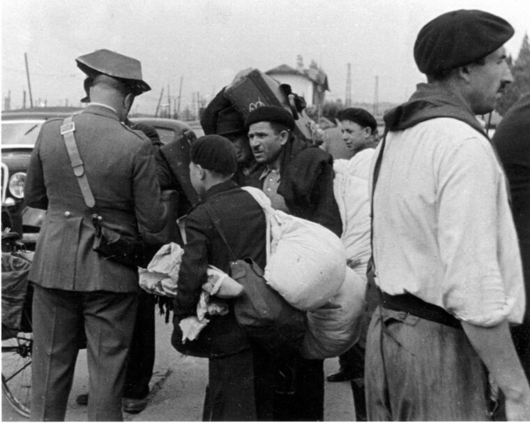 A Spanish police officer examines papers at a border crossing in 1940.