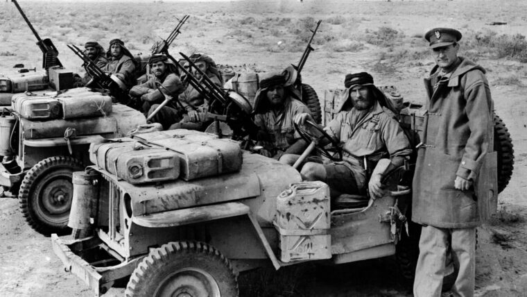 Colonel David Stirling, founder of the SAS, poses with several of his men prior to their departure for a raid. The heavily armed Jeeps usually mounted twin Vickers machine guns and carried provisions for extended forays into the desert.
