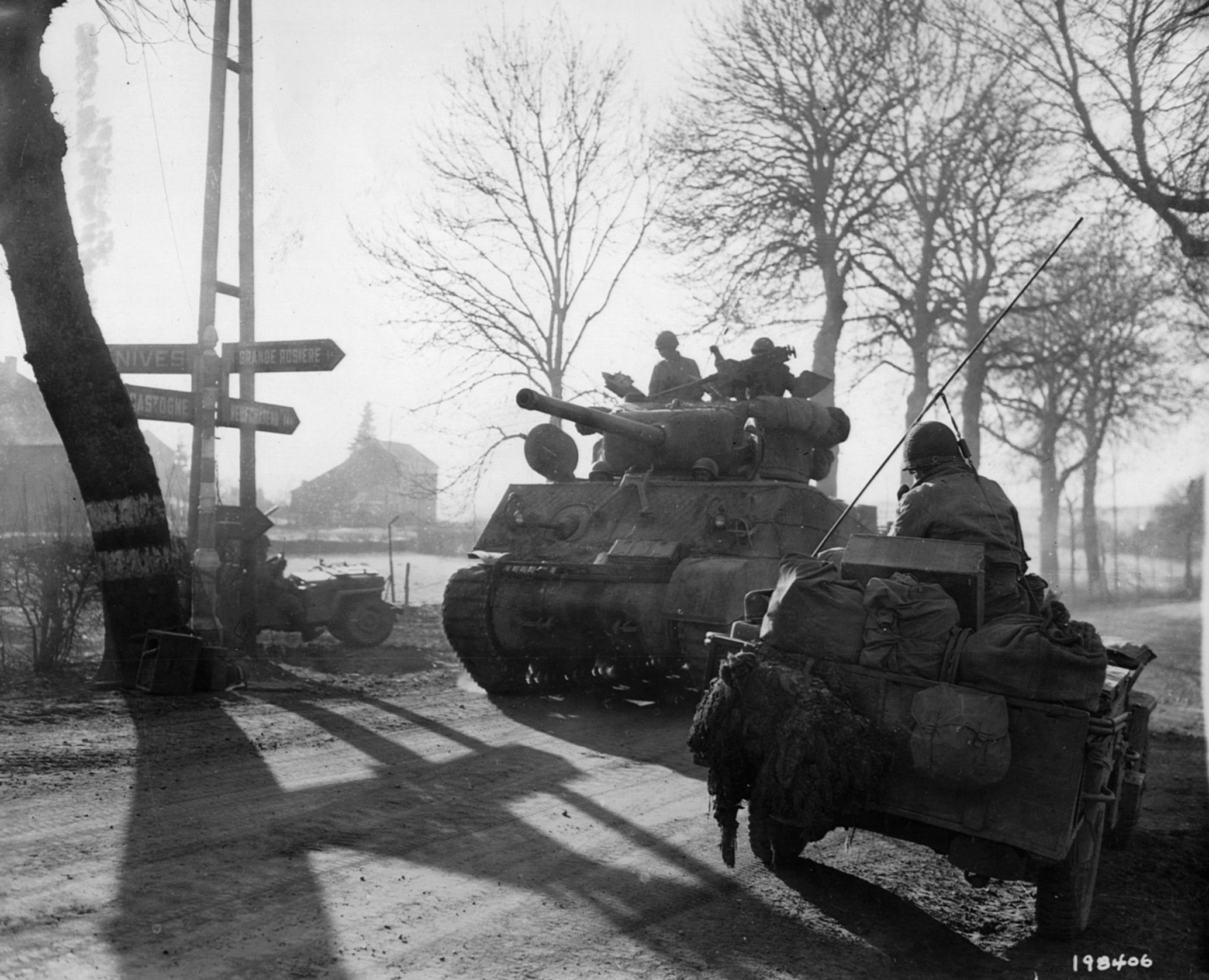 A Sherman tank of the 9th Armored Division heads into action against the advancing Germans during the Battle of the Bulge. The fighting in the Ardennes was some of fiercest of the war on the Western Front.