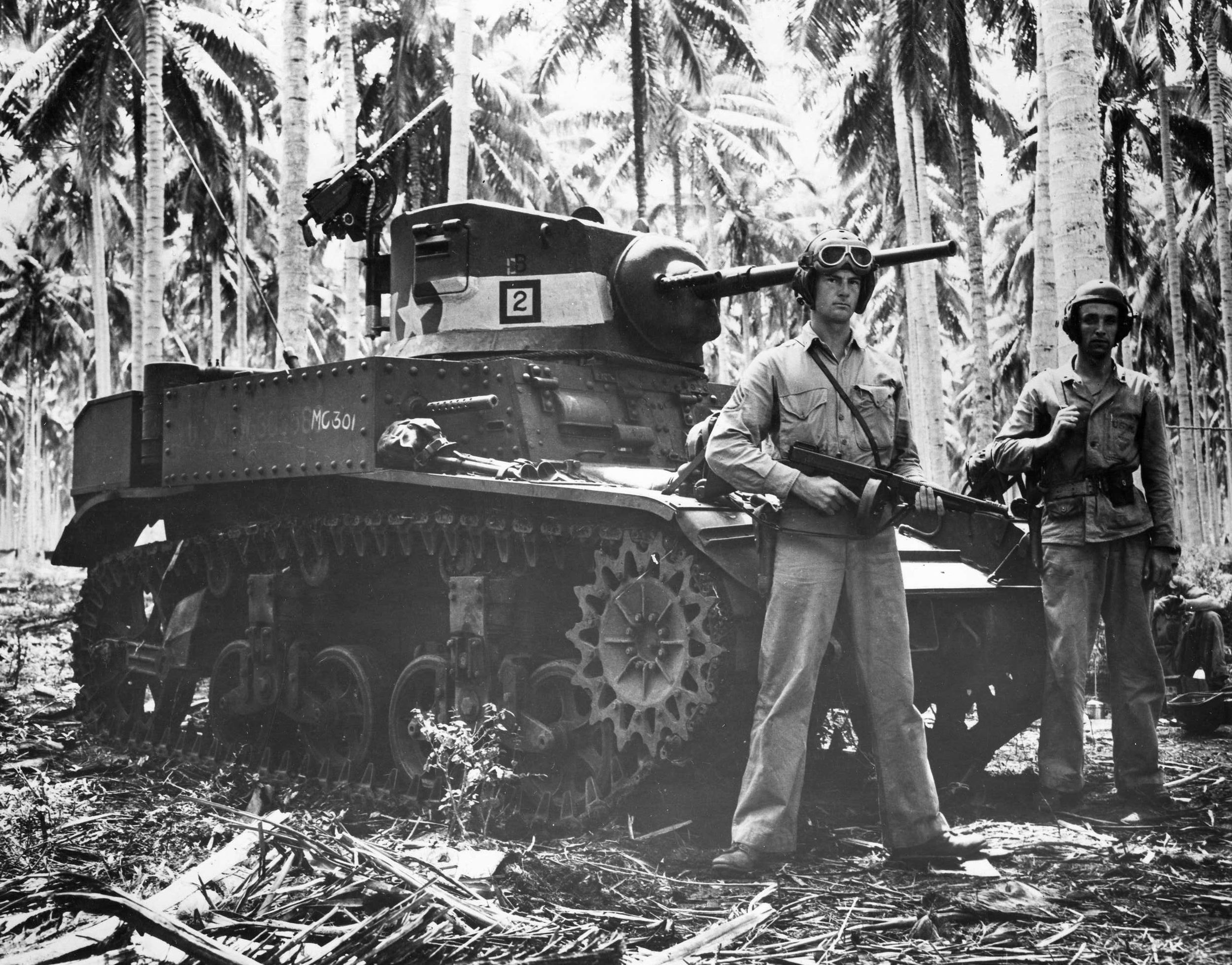 Two American tankers, one of them holding a Thompson submachine gun, stand beside their Stuart light tank, which had recently participated in the fighting at the Tenaru River. U.S. firepower, particularly tanks and artillery, played a pivotal role in the victory on the island. (National Archives)