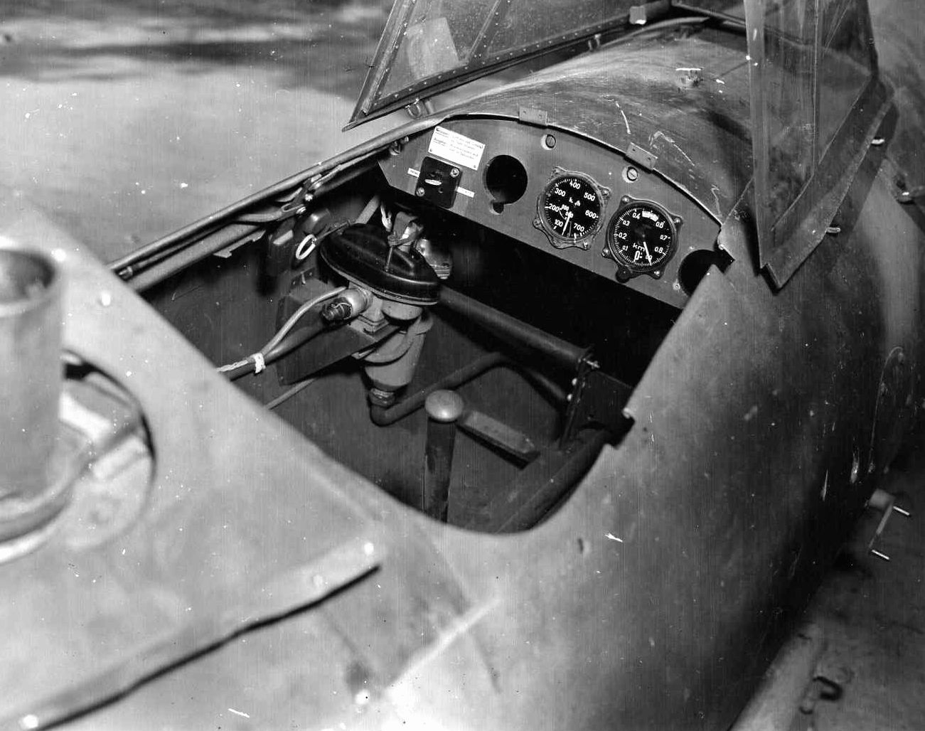 The cramped cockpit of the interior of a Rechenberg Project flying bomb is seen at an assembly facility captured by troops of the U.S. 29th Infantry Division.