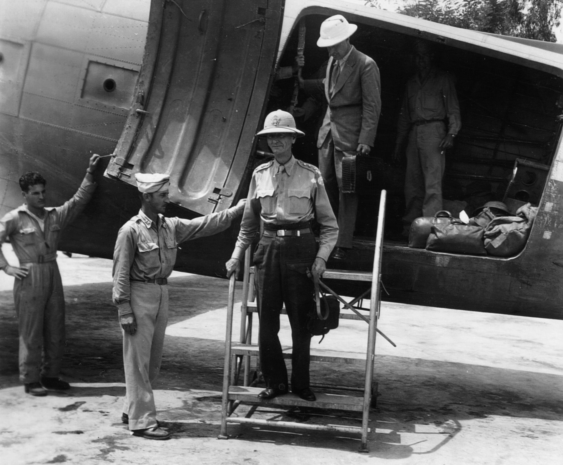 On August 28, 1945, General Jonathan Wainwright steps down from a C-47 transport in Chunking, China, after three arduous years in a Japanese prison camp.