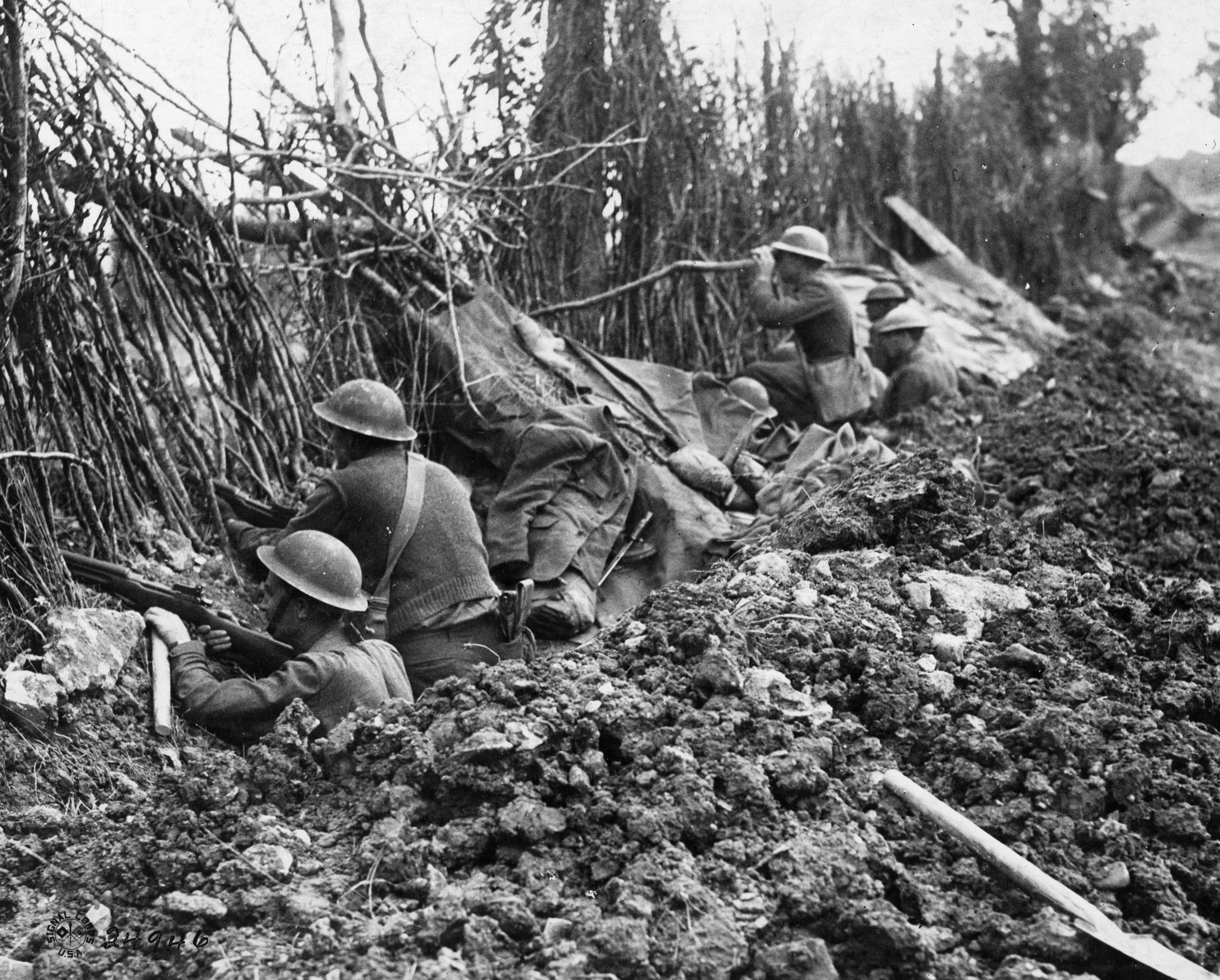 Armed with Enfields, American doughboys man an abandoned German position in the Meuse Valley north of Verdun.