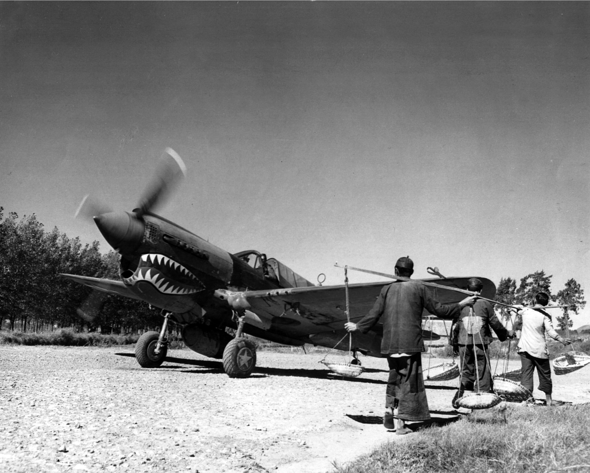 A P-40 of the lengendary Flying Tigers prepares for takeoff from an airfield in a remote part of China. 