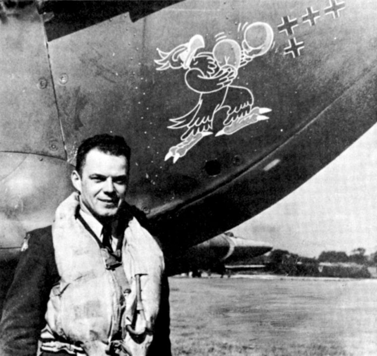 Eagle Squadron pilot William R. Dunn stands beside his fighter plane. The small black crosses denote aerial victories. 