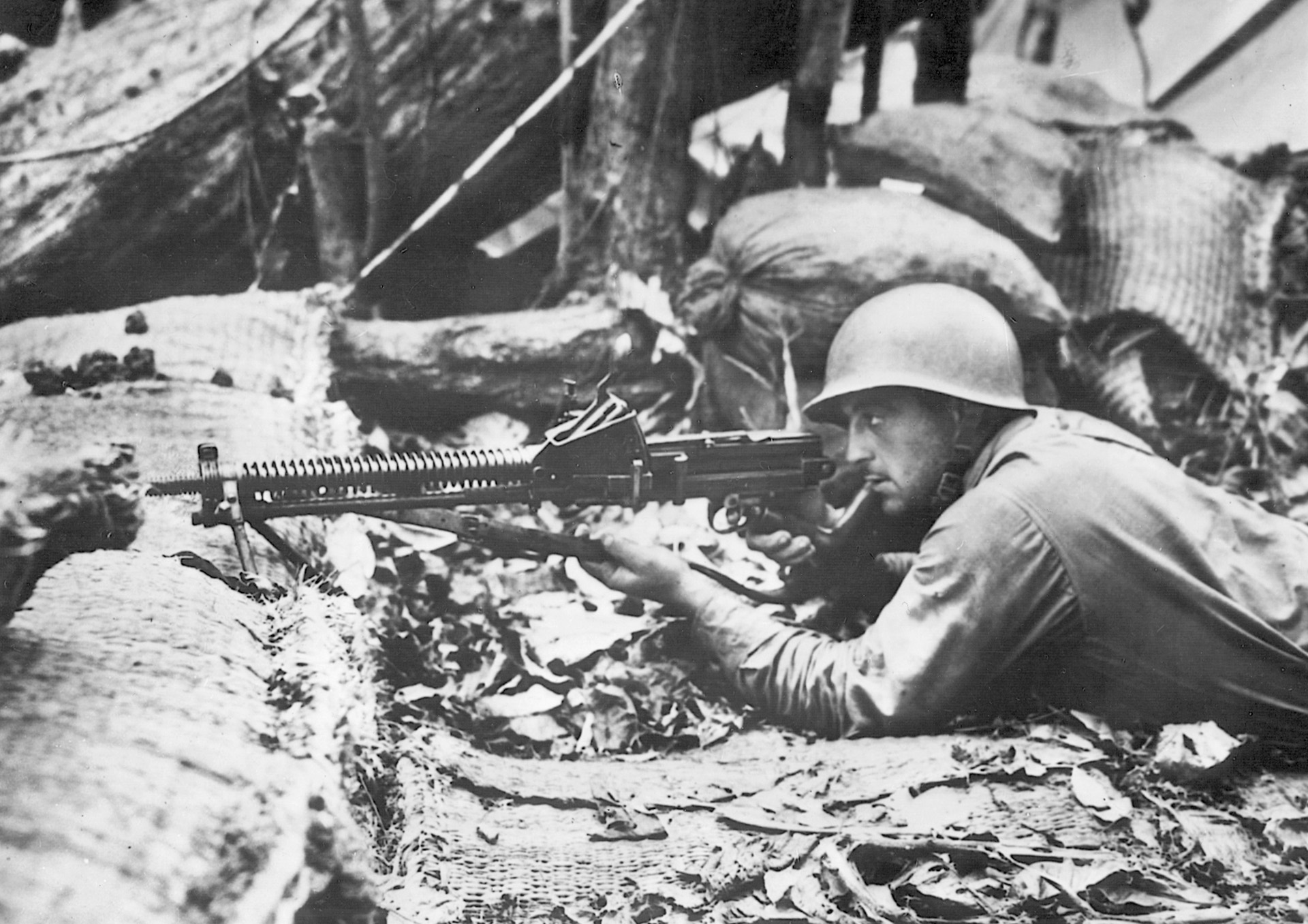 An American soldier takes aim with a captured Japanese 6.5mm light machine gun. The weapon was taken during the savage fighting for Guadalcanal.