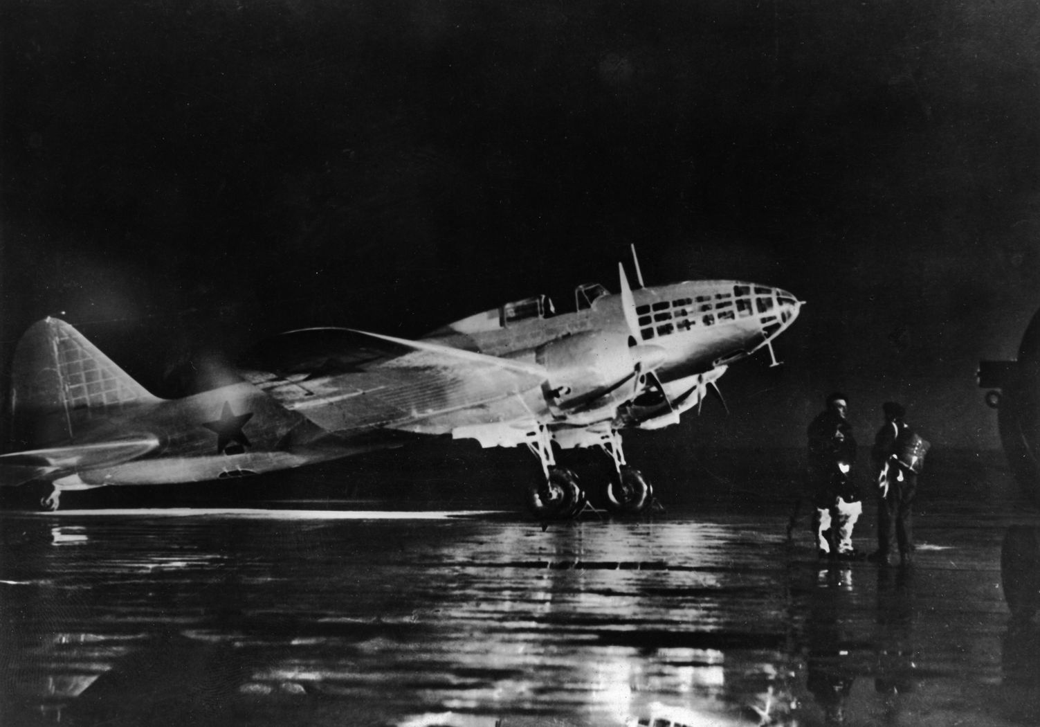 An Ilyushin Il-4 twin-engined bomber, a workhorse of Soviet military aviation, sits on the tarmac at a naval air base near the Baltic coast. The Il-4 began service as the DB-3, and its name was changed in 1942.