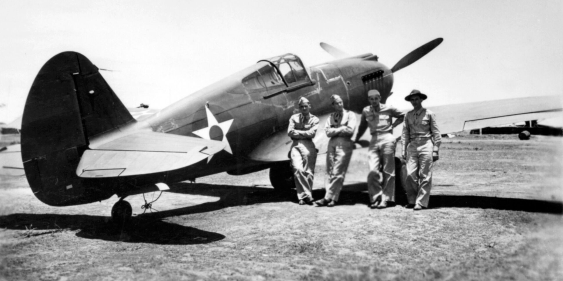 Several American pilots pose at Clark Field in August 1941. Standing left to right are: Carl Gies, Max Louk, Erwin Crellin, and Varian Kieler.