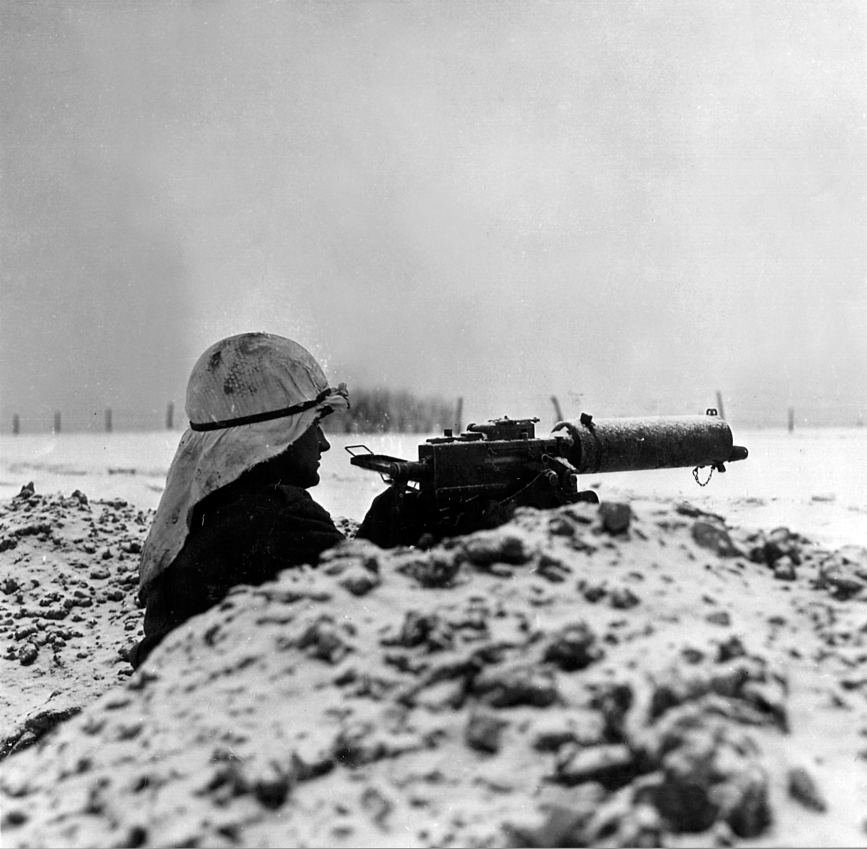 Scanning the horizon down the barrel of his .30-caliber machine gun, this soldier from the 30th Infantry Division watches for signs of enemy movement.