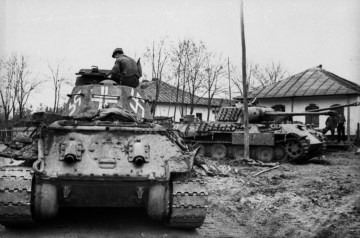 Photographed somewhere in the Ukraine, a captured Soviet T-34 medium tank has been pressed into service with the German Army and painted with swastikas and a white cross for recognition purposes. 