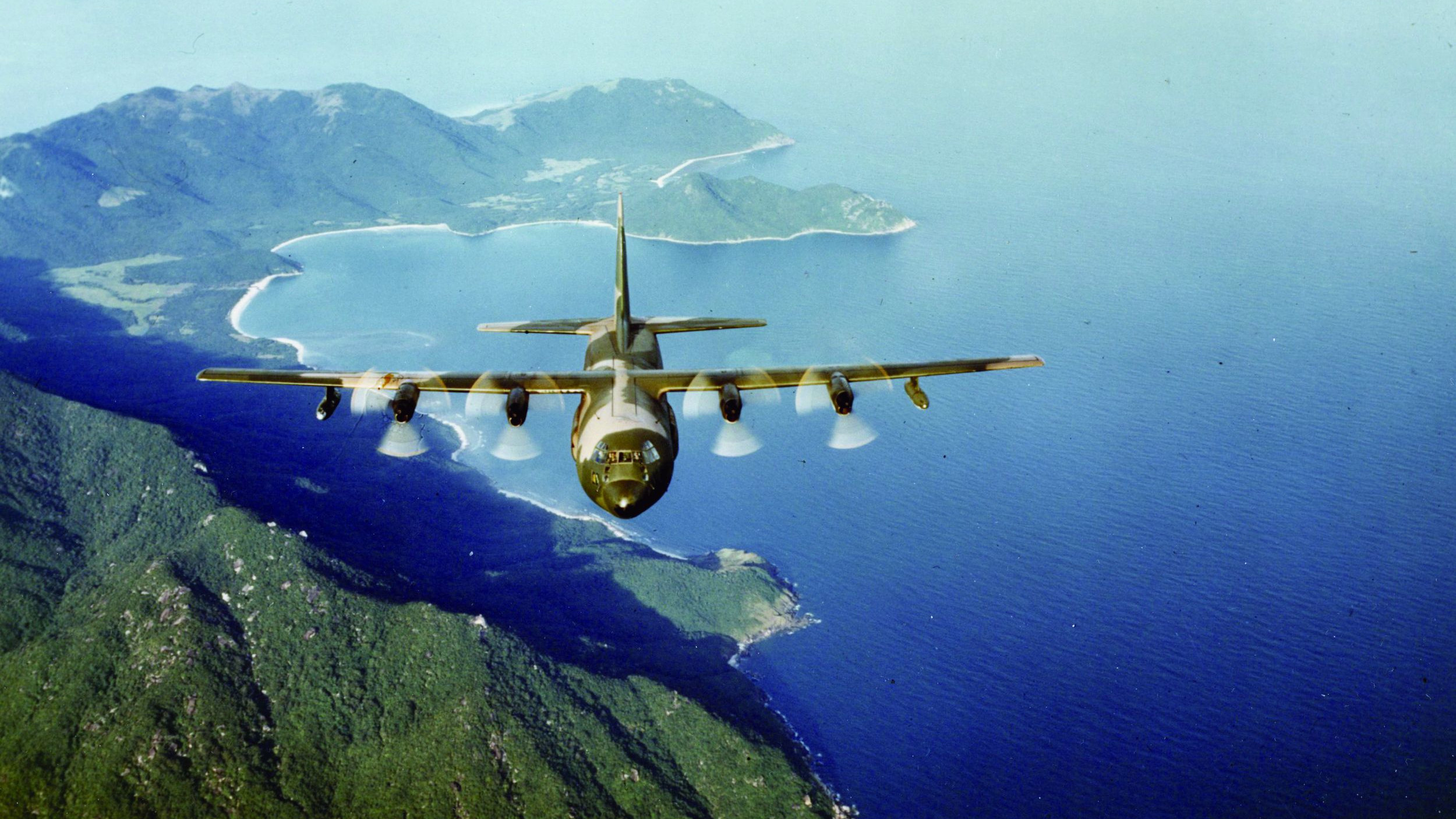 An American C-130 Hercules aircraft over Cam Ranh Bay Air Base in December 1966. The hulking aircraft dropped magnetic mines into the Song Ma River.