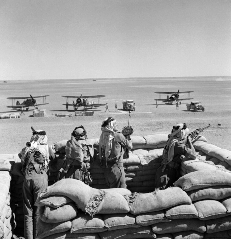 Well-armed members of the Arab Legion guard a fleet of British Gloster Gladiator biplanes during the Iraq campaign in World War II. Some 250 legionaries took part in the campaign.