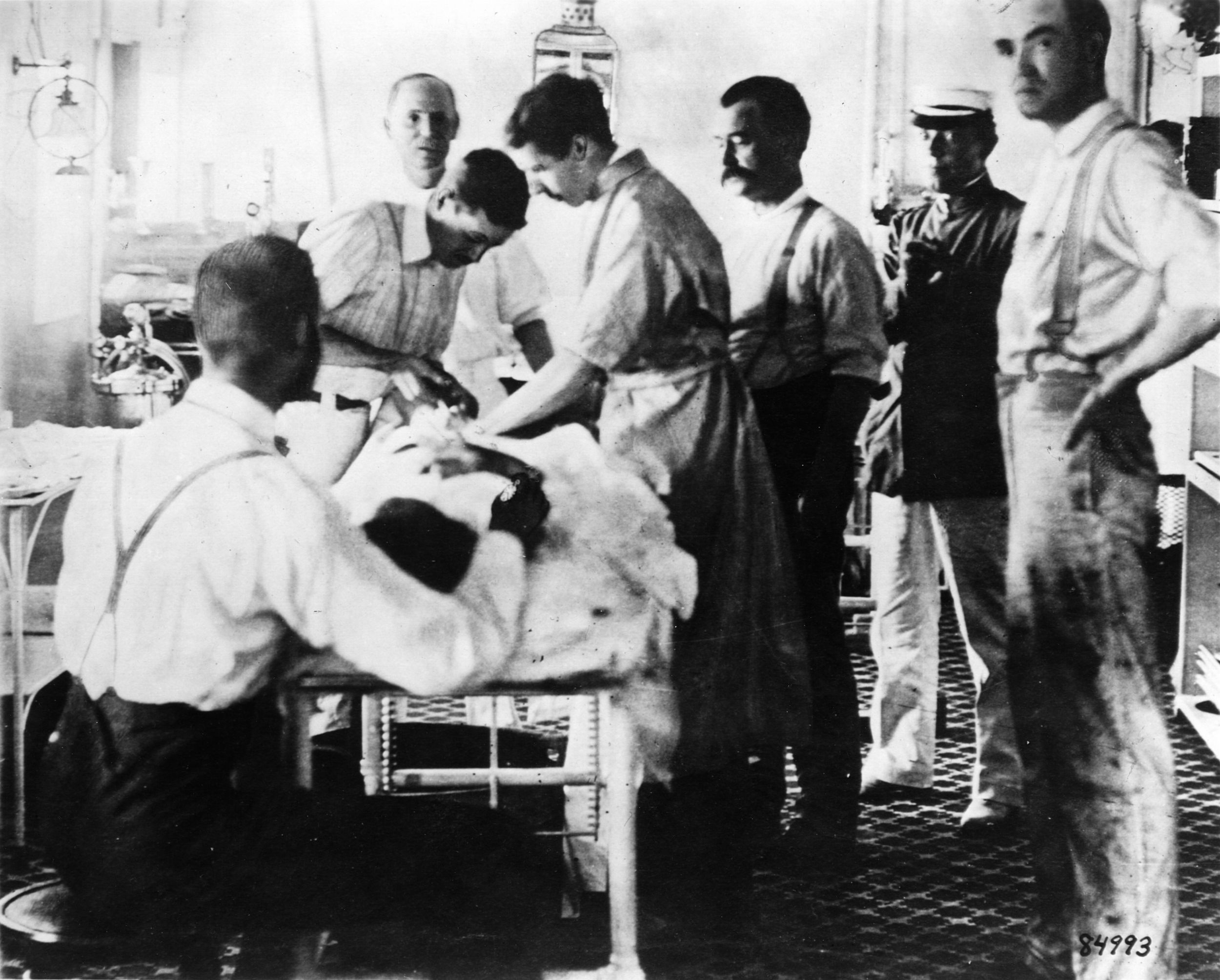 Surgeons operate on a soldier onboard a hospital ship. 