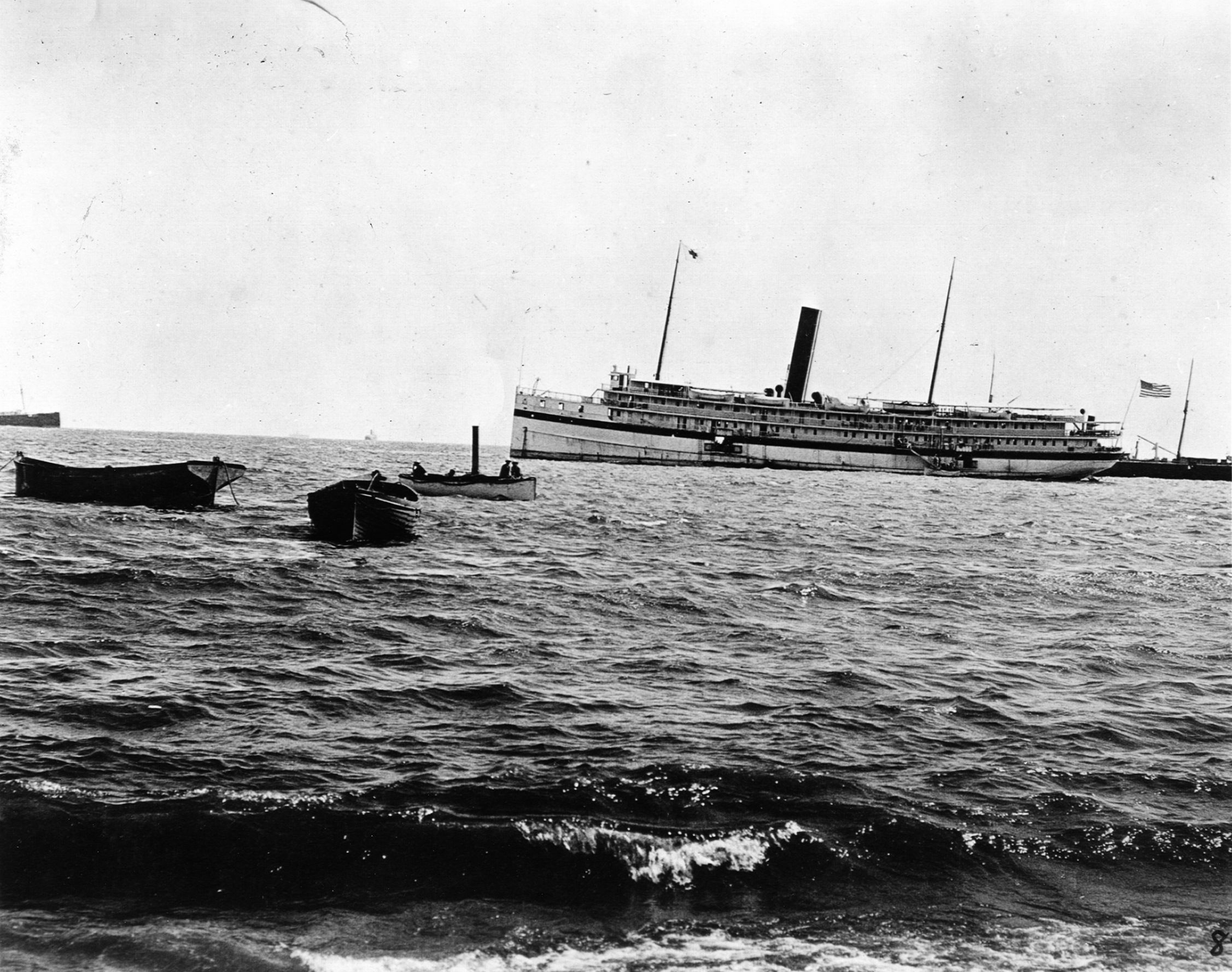 The hospital ship Relief waits off shore for the wounded to arrive. The small ships near the water’s edge brought the men aboard. 