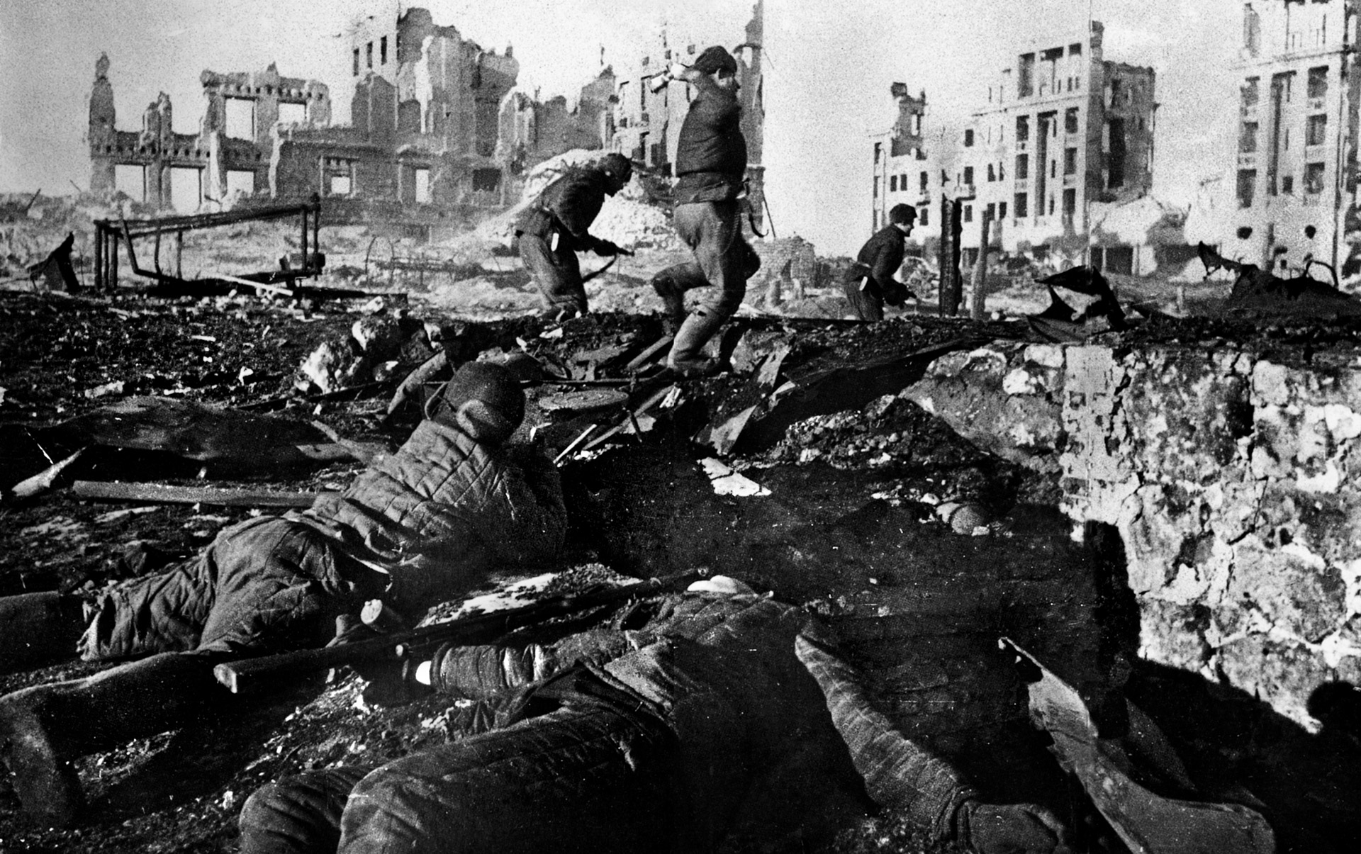 Victorious members of the Soviet Sixty-second Army advance through the rubble of Stalingrad in what is probably a staged photo taken after the battle.
