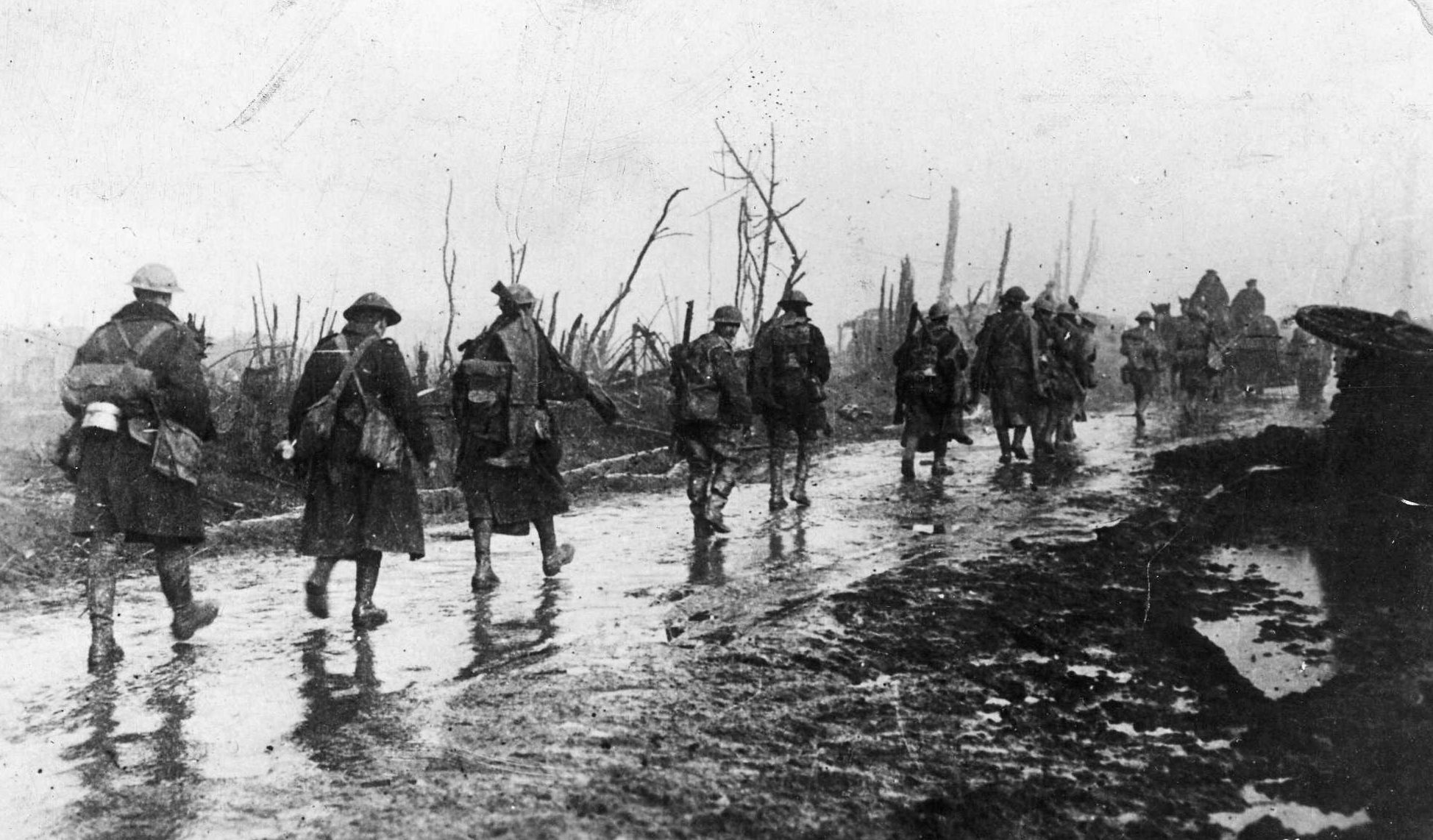 British infantry trudges through the rain toward new lines at Guillemont during the 1916 Somme campaign.