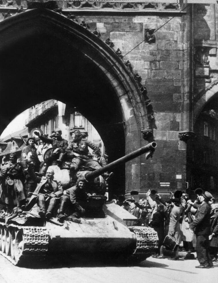 Citizens of Prague welcome the arrival of Red Army tanks on May 10, 1945, as Soviet forces roll into the city.