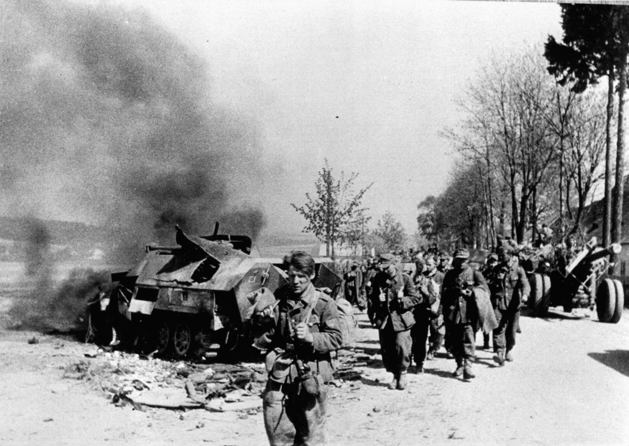A column of captured German soldiers trudges along a road near Prague during the final days of World War II. Many Germans who were captured by Soviet forces never returned home.