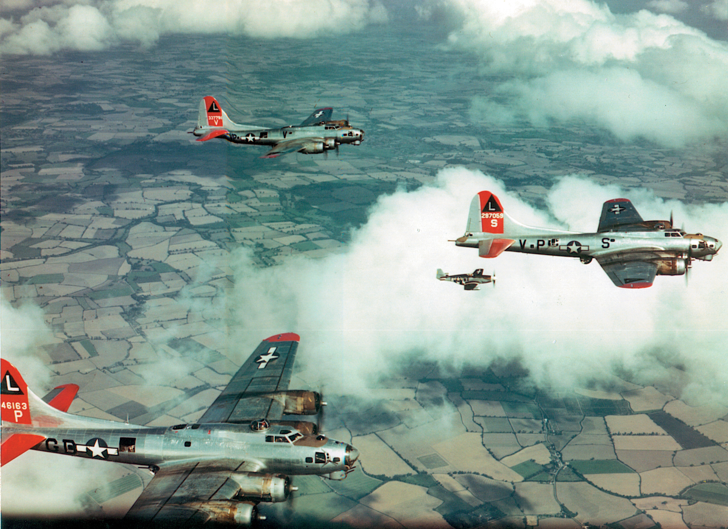 A P-51 Mustang fighter escorts Eighth Air Force bombers during a raid on a target deep inside Germany. The development of a fighter that could accompany the heavy bombers all the way to and from their distant targets helped to reduce losses from attacks by German fighters defending their homeland.