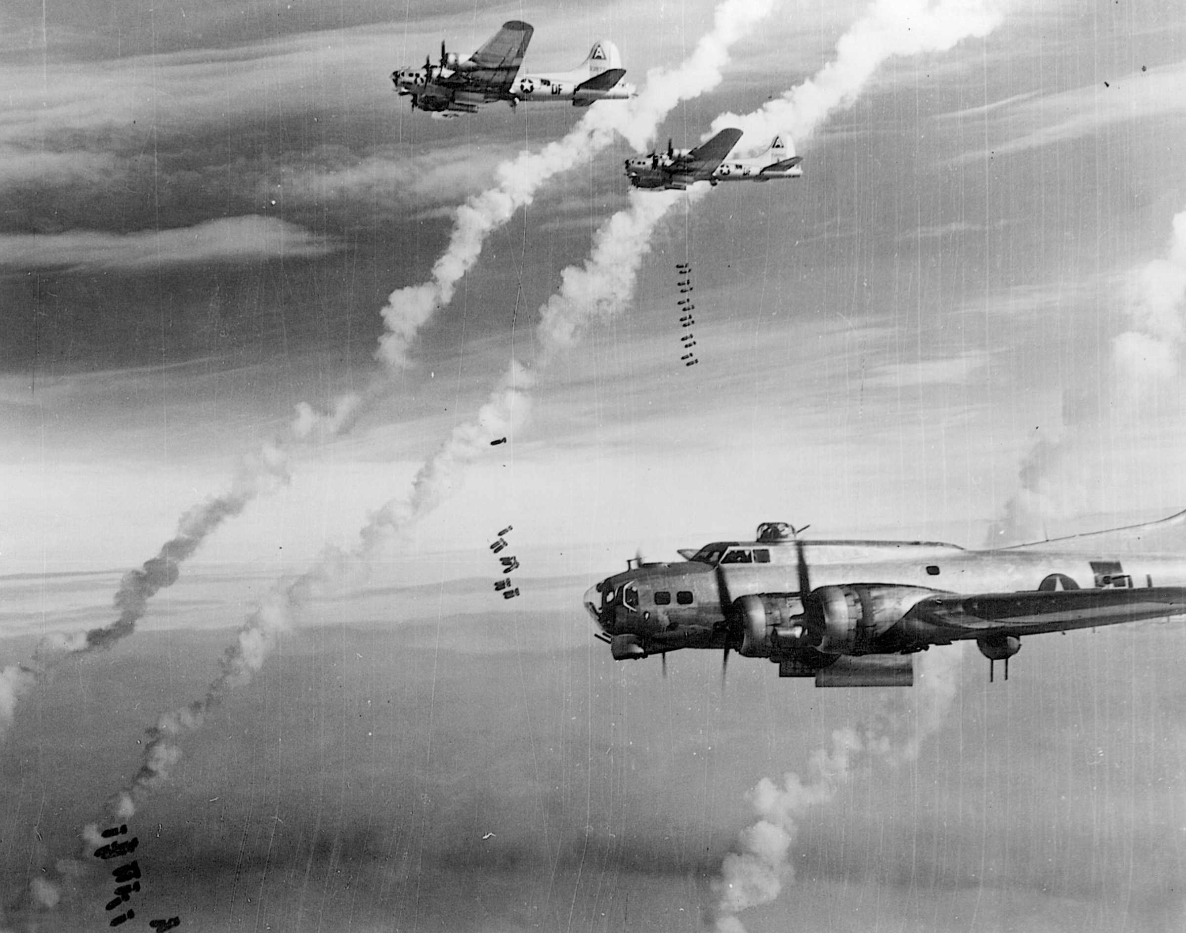 High above Berlin, Eighth Air Force B-17s drop their cargoes of destruction on February 28, 1945. The bombers paid repeated visits to Berlin by day, while the British Royal Air Force bombed German cities by night.