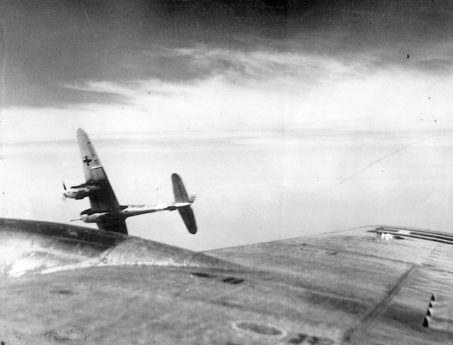 A German fighter, less than 25 feet from a Flying Fortress, banks sharply away from the American bomber after pressing home its attack on June 21, 1944. Luftwaffe pilots flew countless sorties against the big bombers, which rained death and destruction on major German cities.
