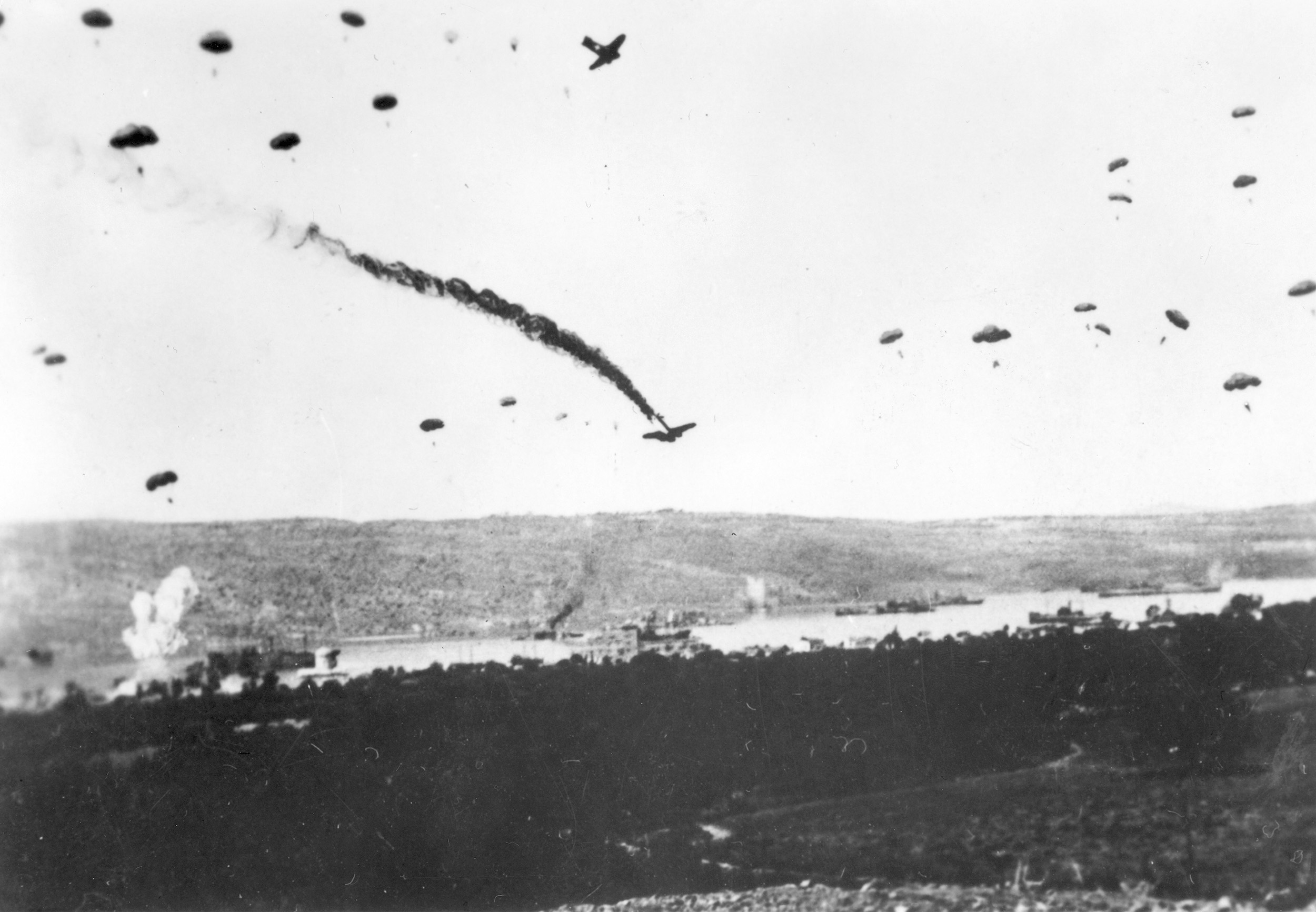 A German Ju-52 transport burns fiercely as it plunges earthward on May 21, 1941. Heavy British antiaircraft fire brought down numerous German planes over Crete, some still carrying their complement of paratroopers. This action took place in the skies above the Akrotiri Peninsula. 