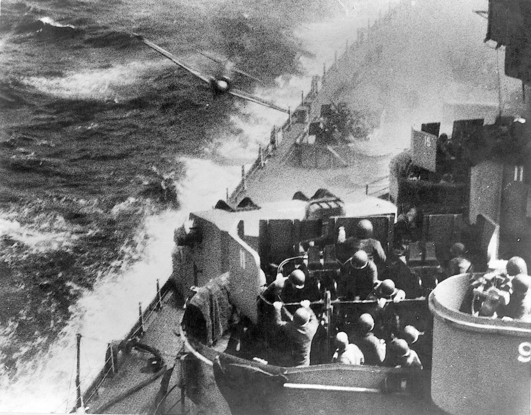 Gunners aboard the battleship USS Missouri work feverishly to take a diving Japanese kamikaze under fire. During the Battle of Okinawa, U.S. naval forces were repeatedly subjected to attacks by enemy suicide planes.
