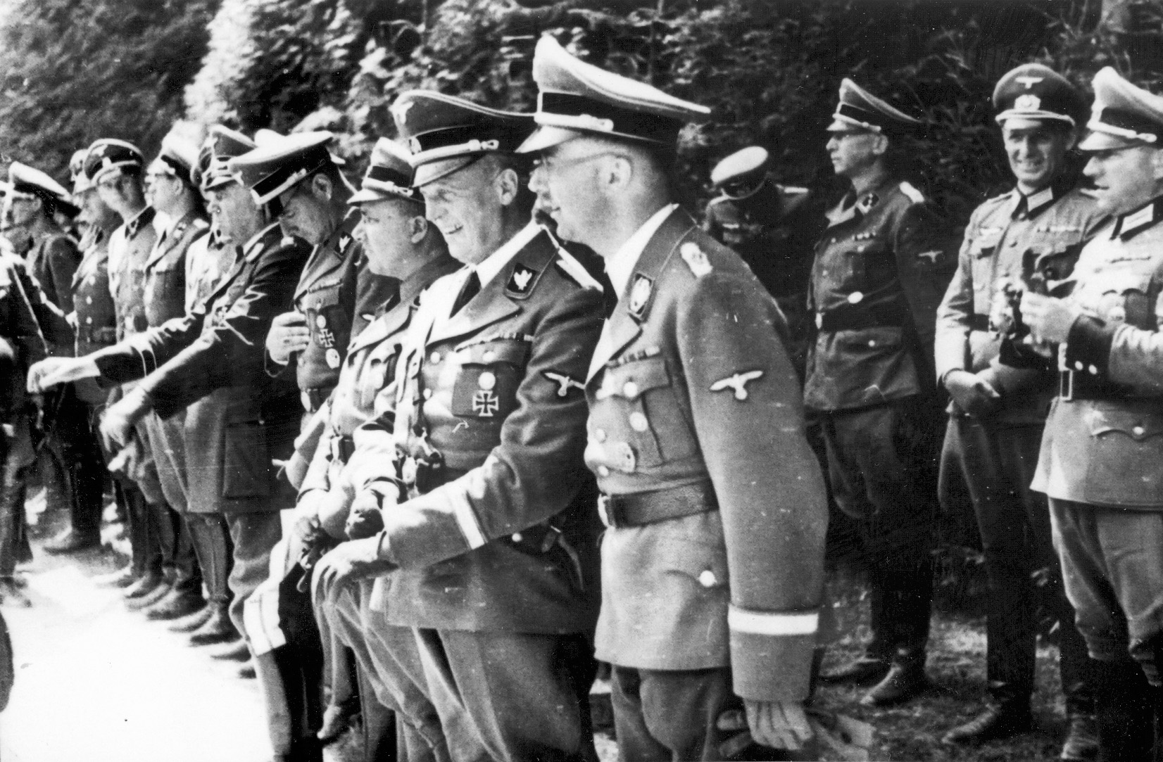 In the front row, right to left, SS Reichsführer Heinrich Himmler, chief planner of the Final Solution; Reich Chancellery head Dr. Hans Lammers; and Reich Leader Martin Bormann observe the ceremonies marking the surrender of France at Compeigne on June 21, 1940.