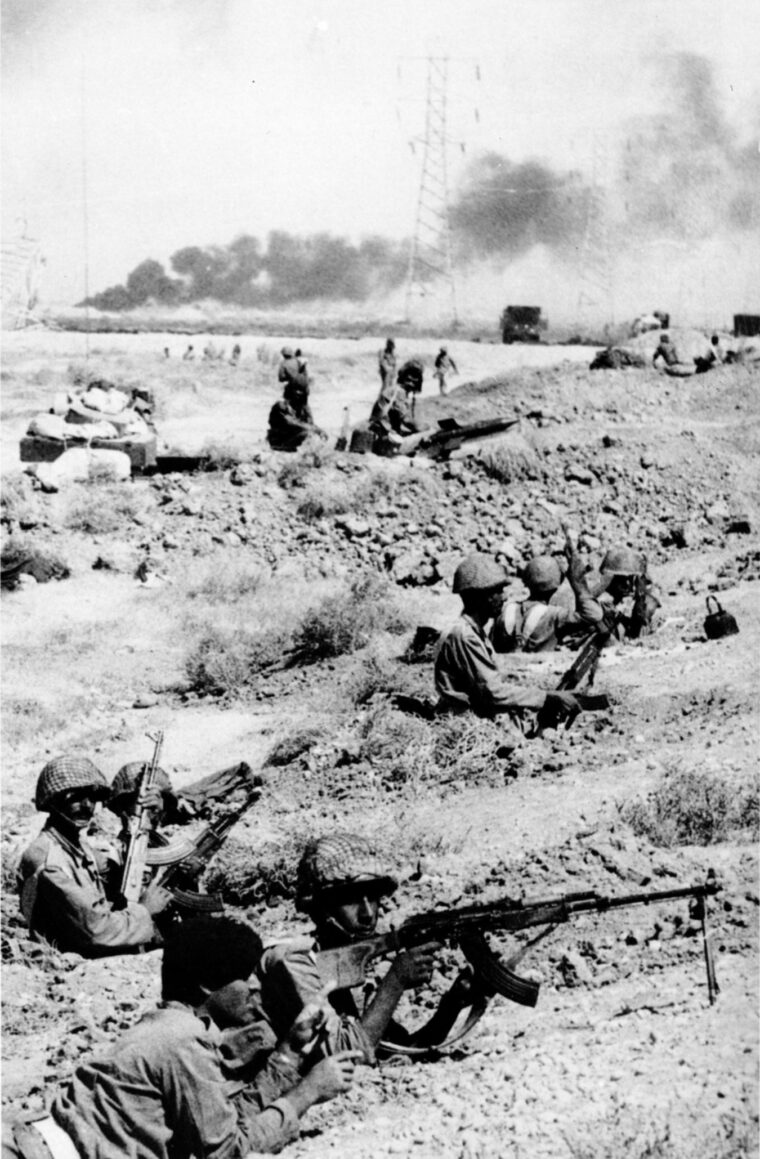 Hunkered down in their trenches, Iraqi soldiers armed with light infantry weapons and antitank missiles man a defensive position on the central front. 