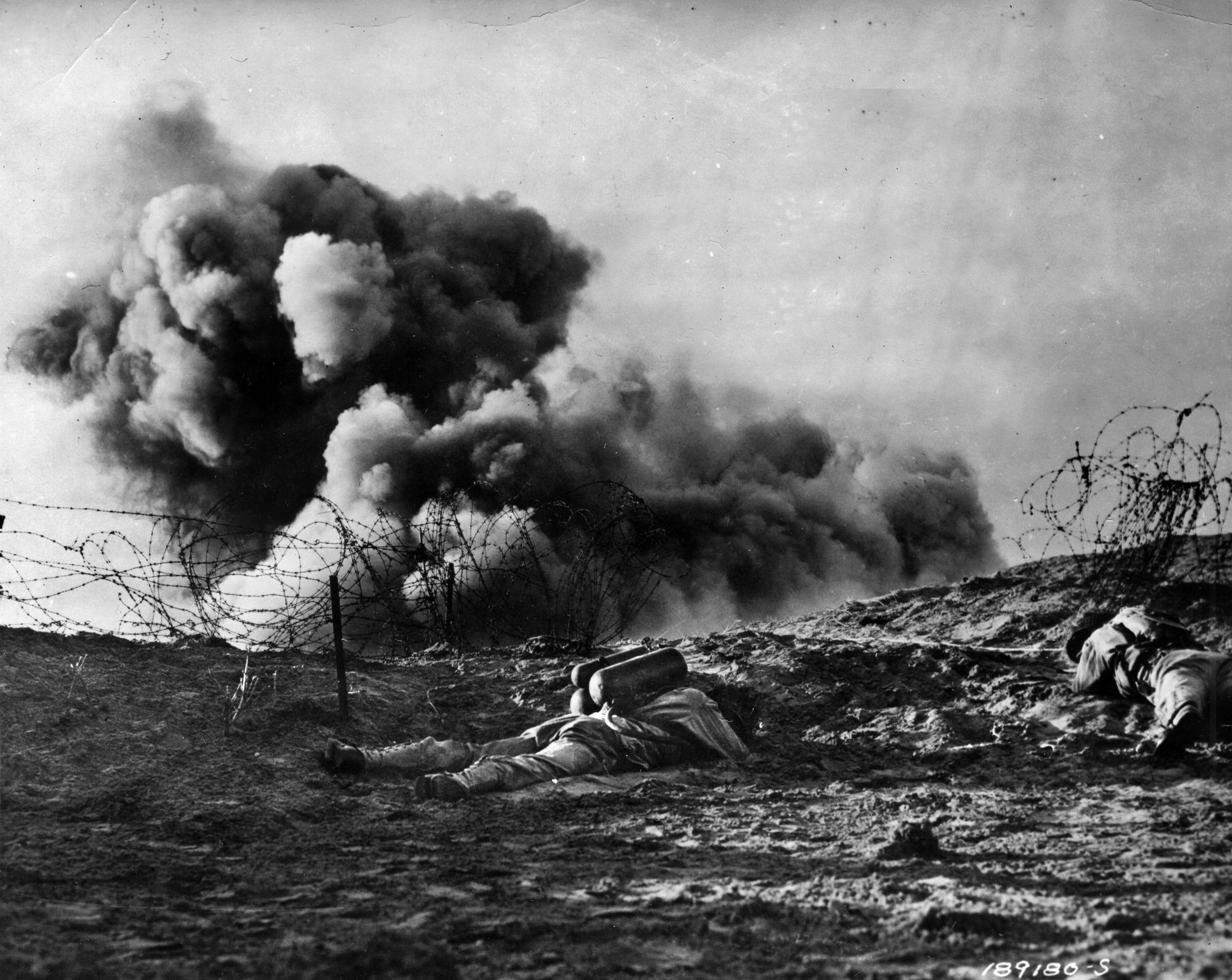 Soldiers practice for their landings on D-Day. These troops are using the Bangalore torpedo, specially designed to blast gaps in barbed wire obstacles. Many of these specialized weapons were lost in the opening minutes of the D-Day landings at Omaha Beach due to strong German resistance and the weight of combat gear, which contributed to the drownings of numerous soldiers who exited their landing craft in water that was above their heads.