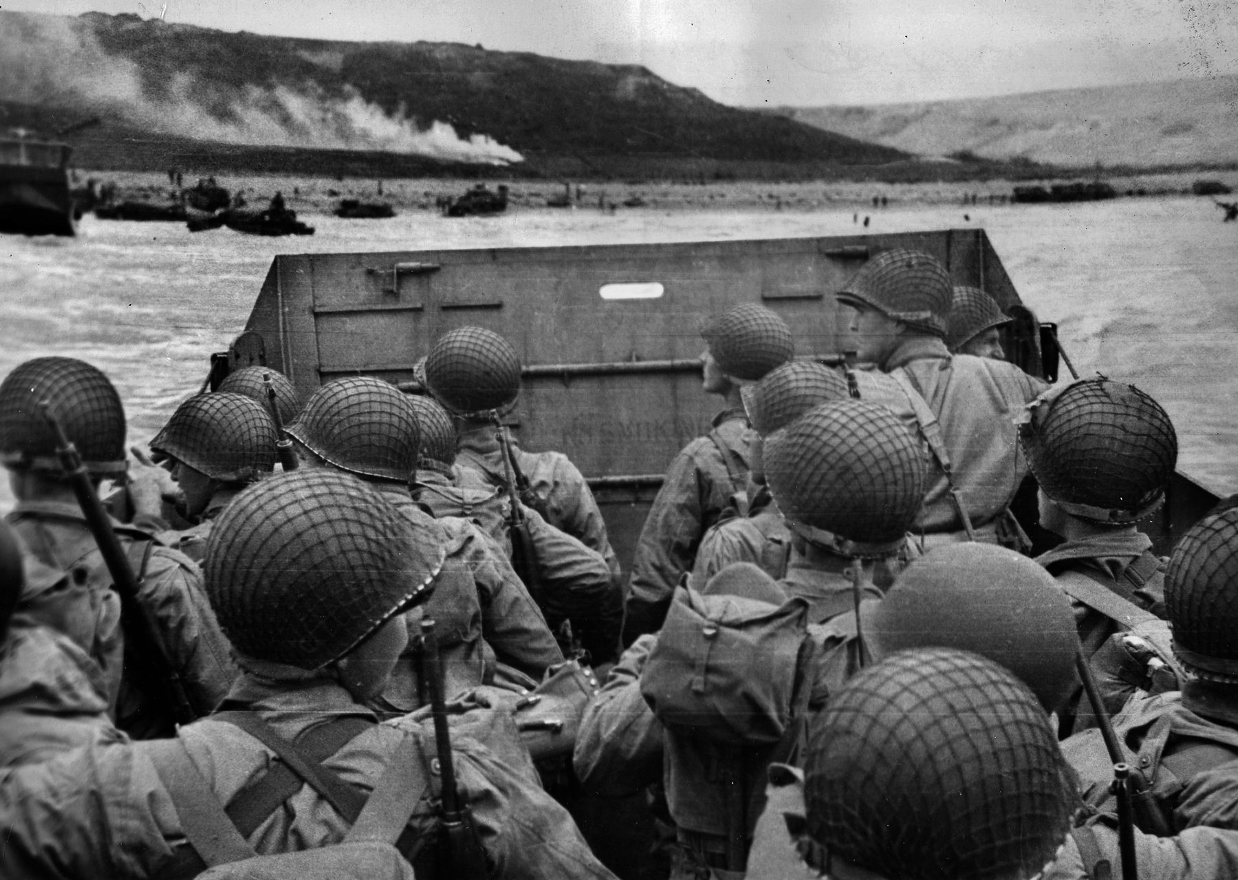 American soldiers crowd the flat bottom of an LCVP, or Higgins boat, as they approach Omaha Beach at Normandy. They are equipped with M1 Garand and M1 Carbine rifles, while their combat loads often weighed in excess of 60 pounds. Concentrated German fire caused some landing craft to stop short of the beach and discharge their cargo of infantrymen into deep water.