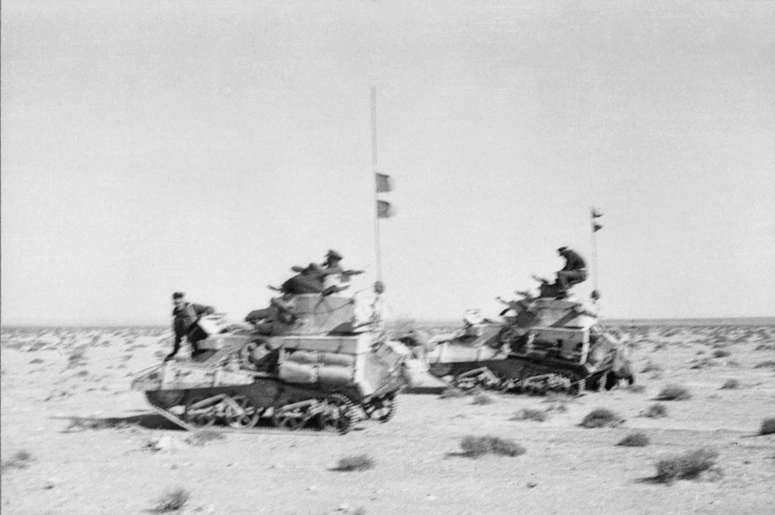 British light tanks of the 3rd Hussars speed across the desert en route to Buq Buq during Operation Compass in December 1940.