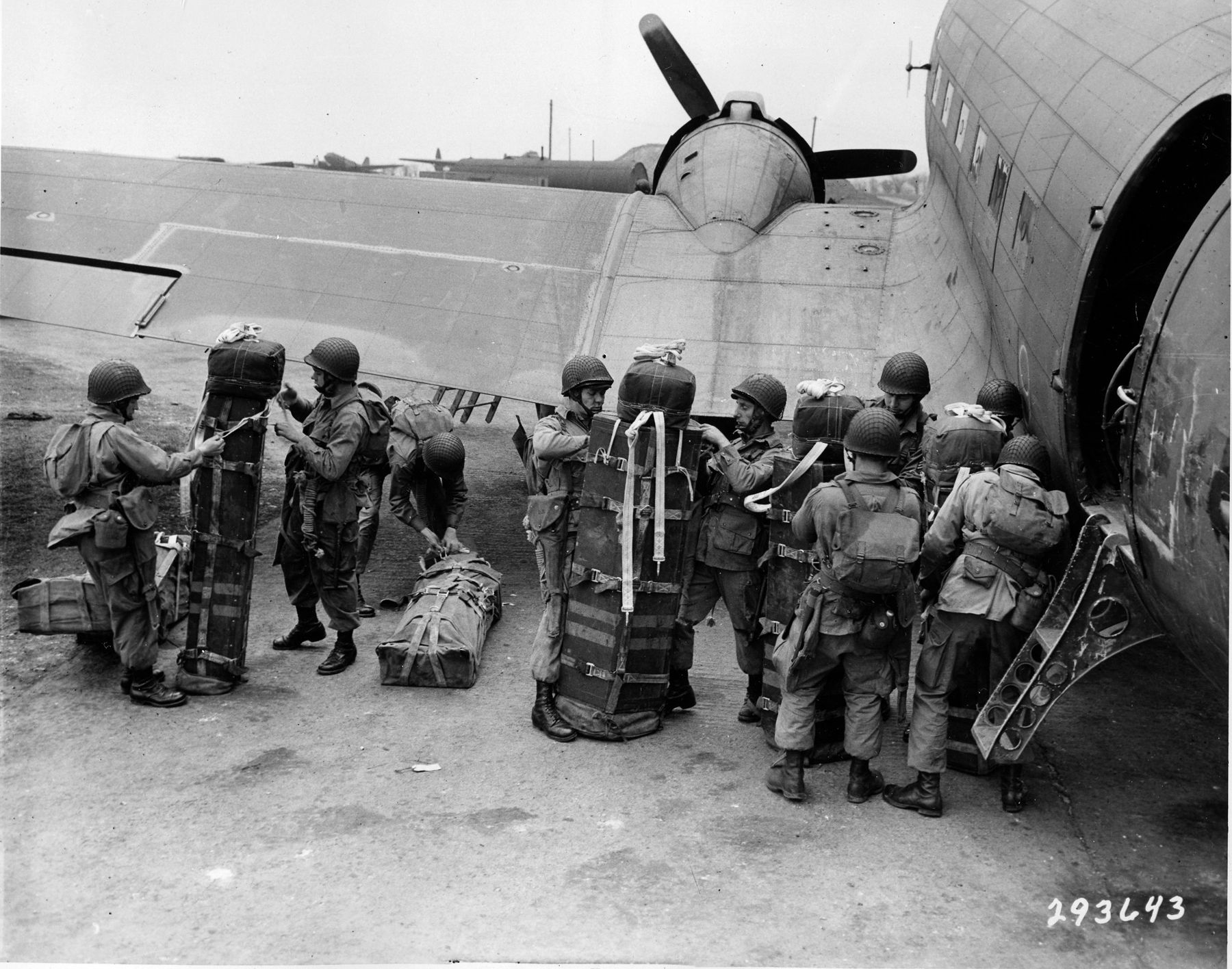 Airborne Soldiers of the 101st Airborne Division load equipment onto a C-47 in preparation for a jump. Mauser carried so much equipment for the D-Day assault that his comrades had to shove him into his plane.