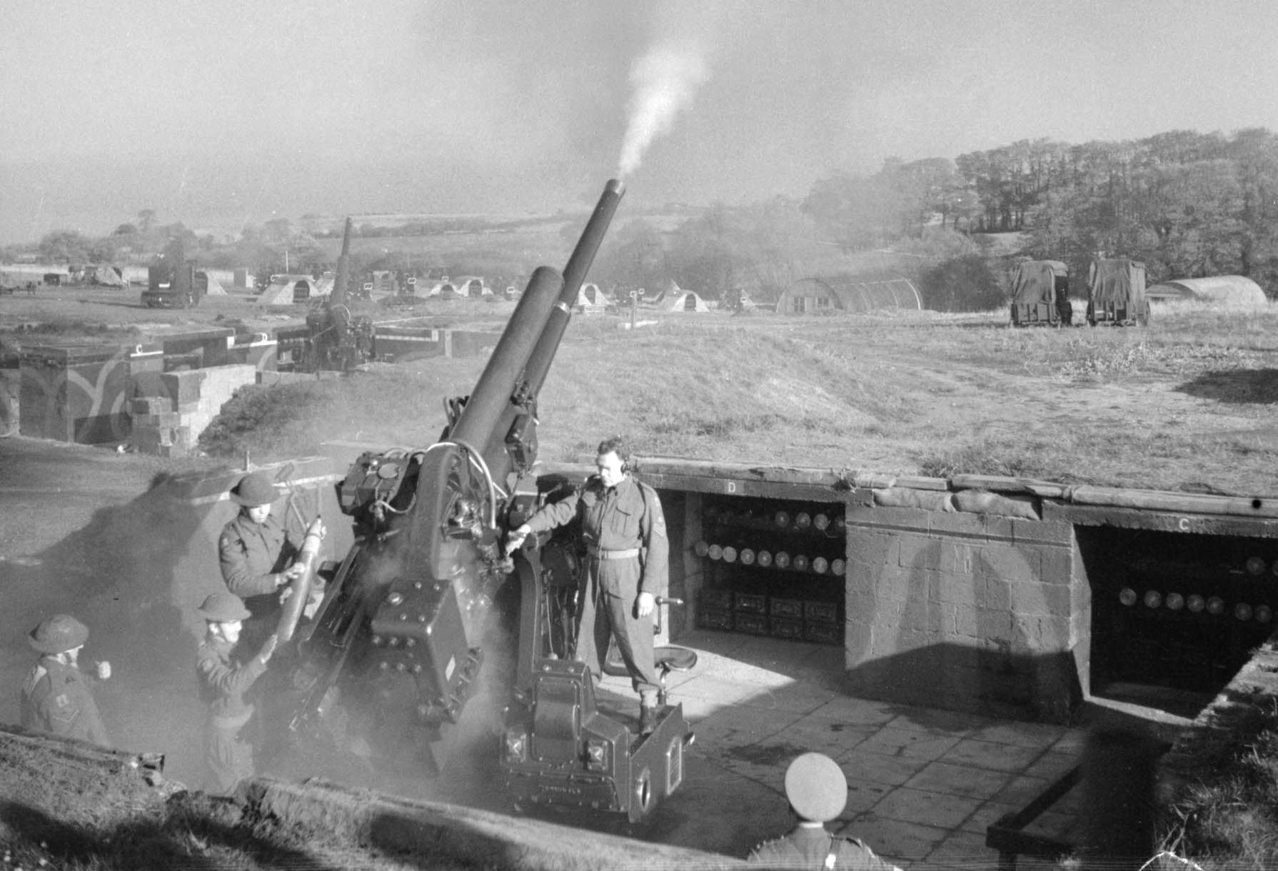 A 3.7-inch antiaircraft gun discharges its shell skyward during fighting in Italy in November