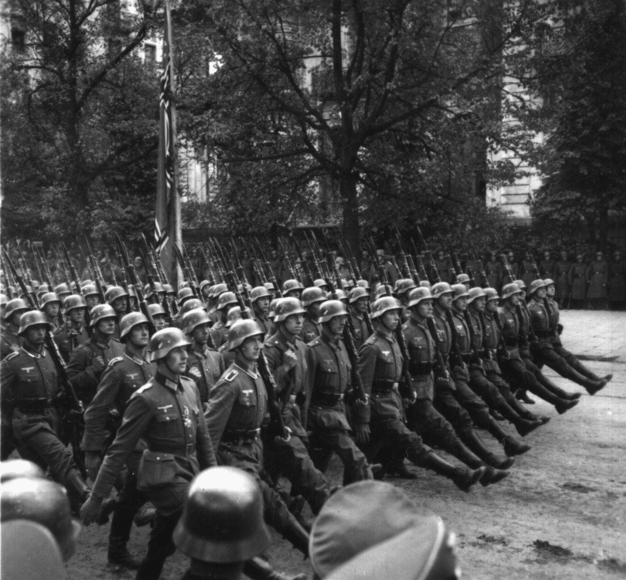 Goose stepping German soldiers parade down a Berlin street. According to some scholars, these troops were set in motion following a secret meeting at the Reich Chancellery and the drafting of the German blueprint for war, the Hossbach Memorandum.