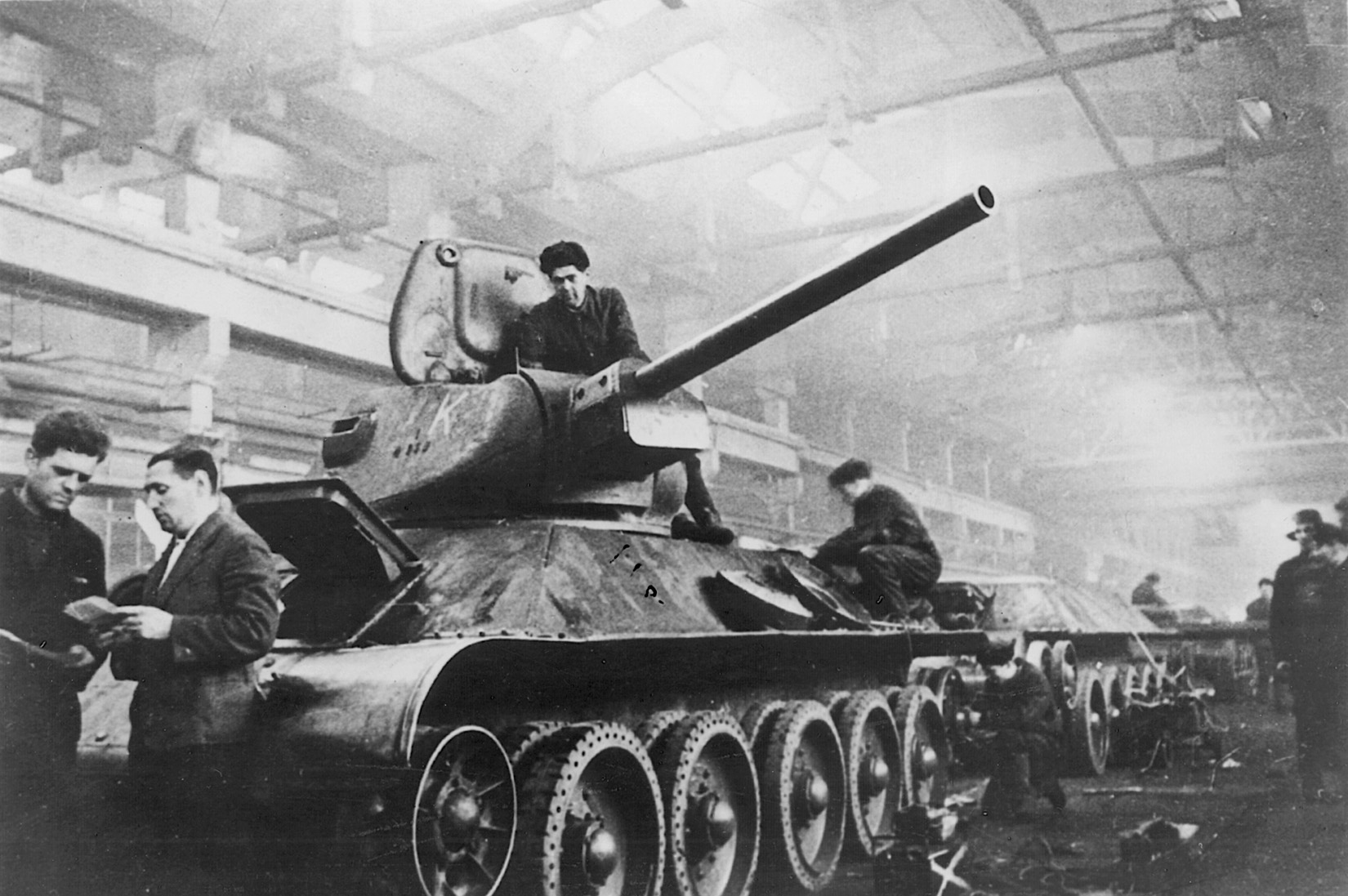 Workers make final adjustments to the turret and chassis of a new T-34 medium tank. Many of these stalwart fighting vehicles were driven straight from the factory into combat.