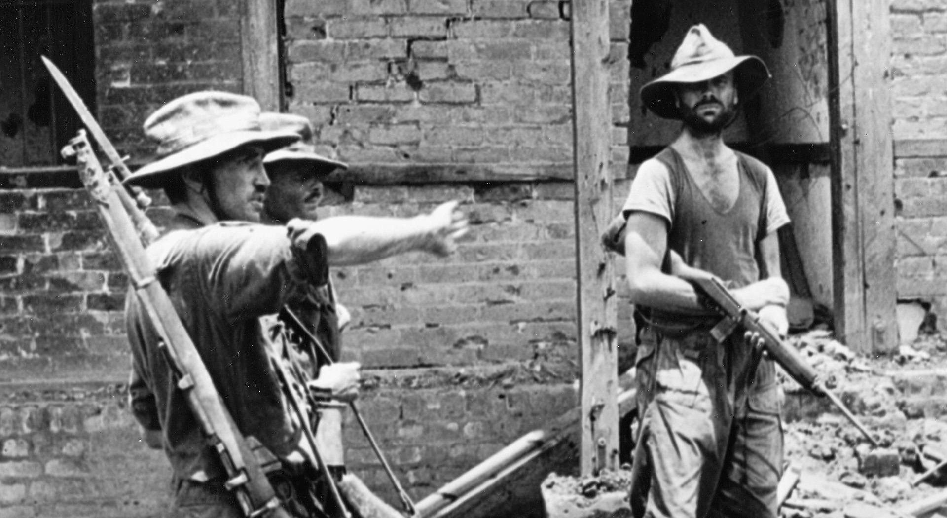 “Mad” Mike Calvert, left, Lt. Col. Shaw, and Major James Rutherford, right, with 77 Brigade in a Burmese village.