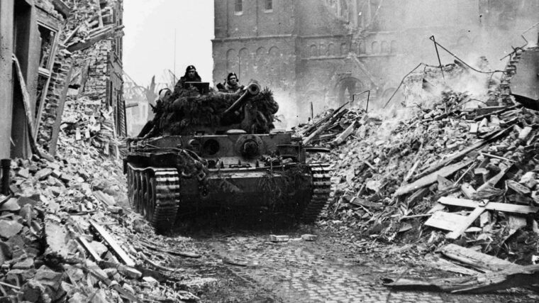 Troops and armor of the Canadian First Army cautiously enter the French town of Calear on February 28, 1945. The Germans had previously evacuated the area, but they later stood and fought the Canadians viciously. (National Archives)