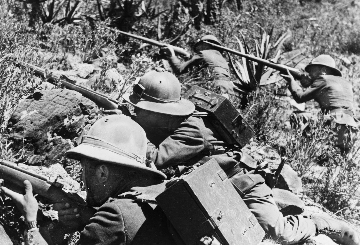 Wearing their signature pith helmets, Italian troops take up concealed positions among the scrub brush of the East African desert. Italian soldiers fought with determination during the campaign in East Africa; however, they were often ill-equipped and poorly led. 