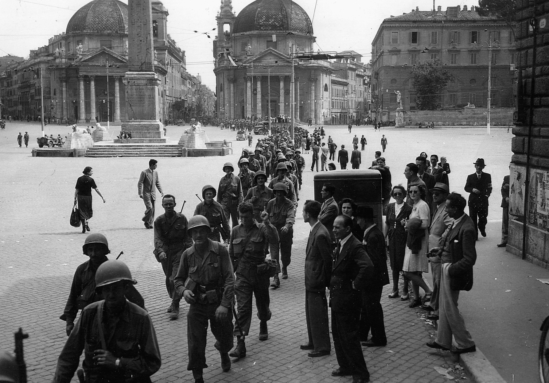 En route to the front, soldiers of the 85th Infantry Division march through the Piazza Del Popolo in the liberated Italian capital of Rome.